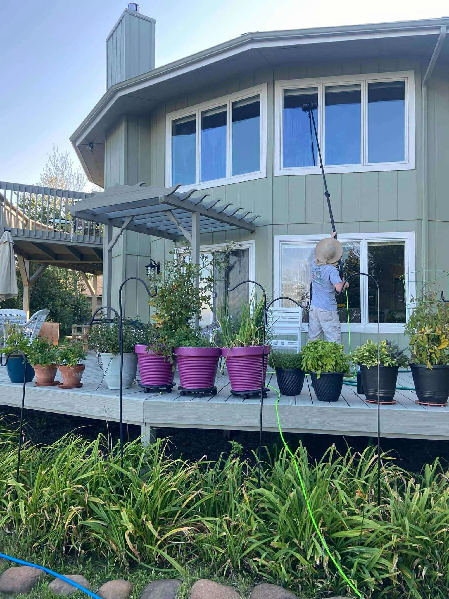 Cleaning home exterior windows using the water-fed pole system; allowing for both scrubbing and cleaning from a ground level.