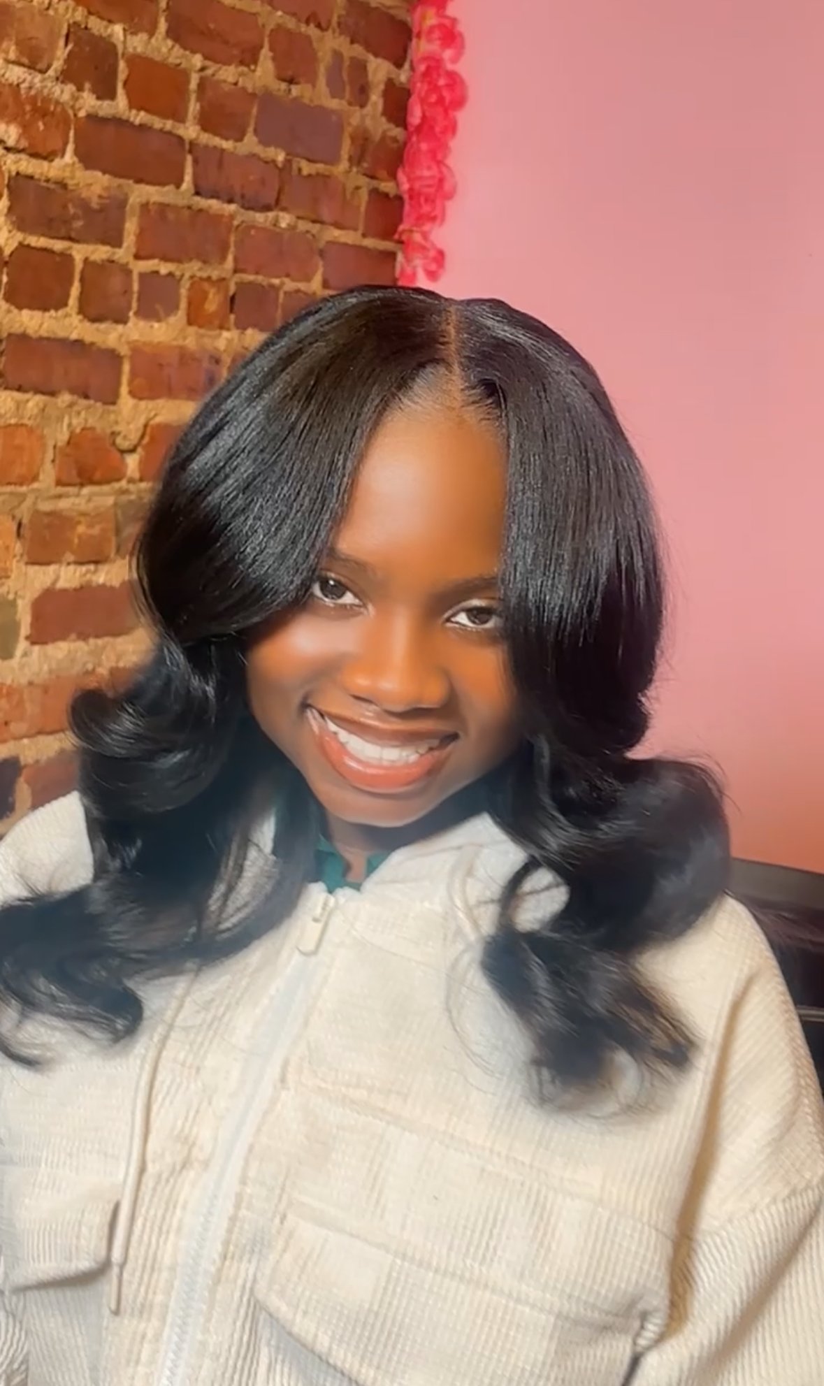  “Natural-looking sew-in install on Black woman with soft curls in Philadelphia salon
