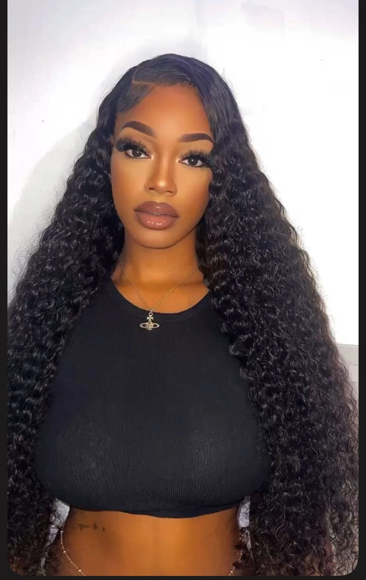 Before and after hair transformation of a client with alopecia restored to full natural looking hair styled in soft loose curls