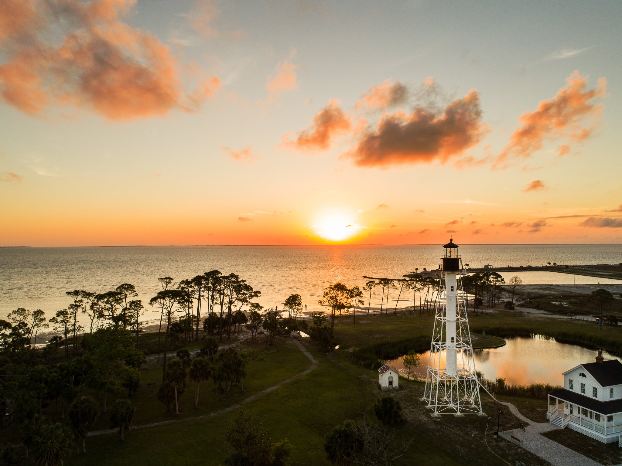 Aerial photograph of Cape San Blas Lighthouse in Port St. Joe Florida at sunset