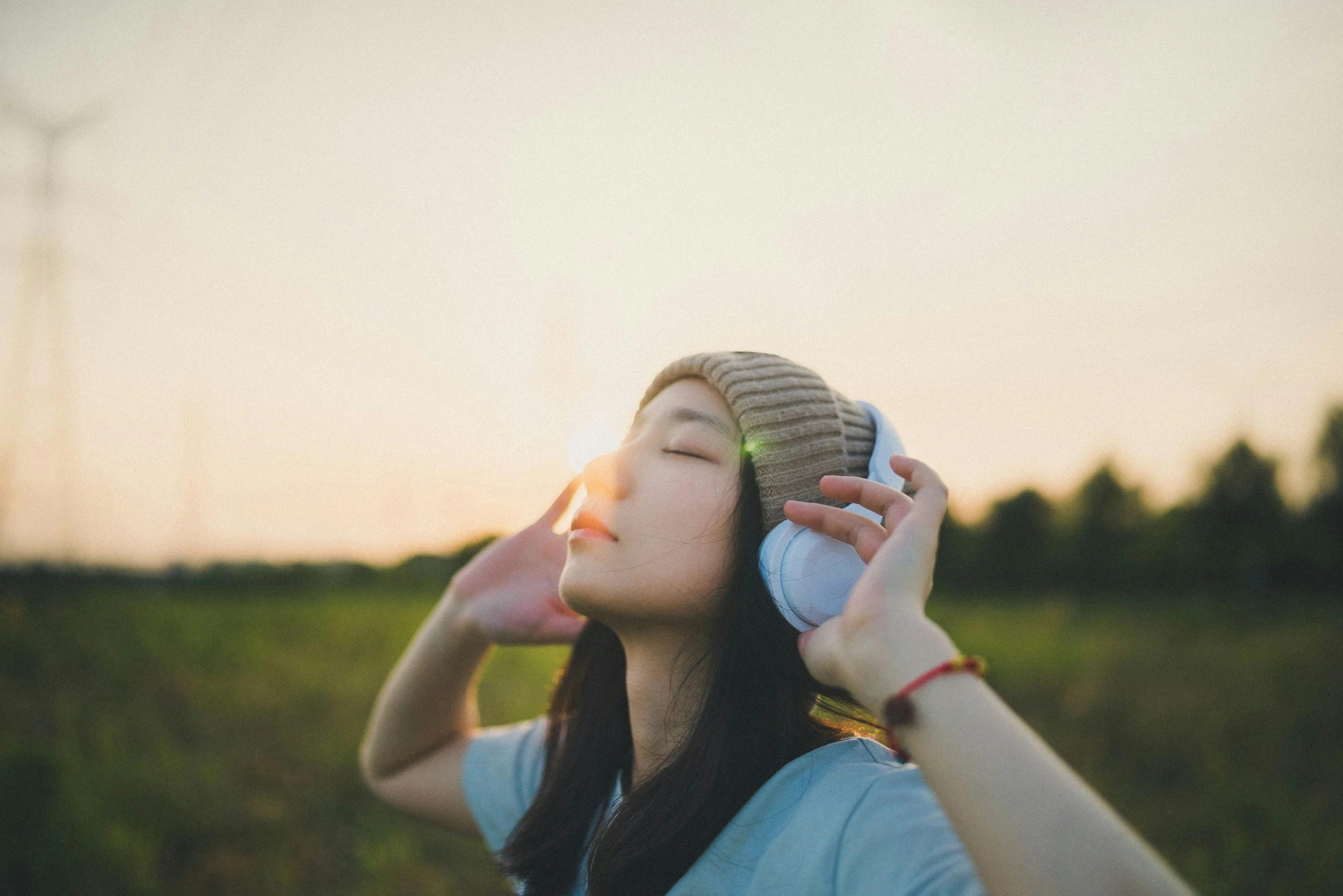 Woman listening to music on headphones.