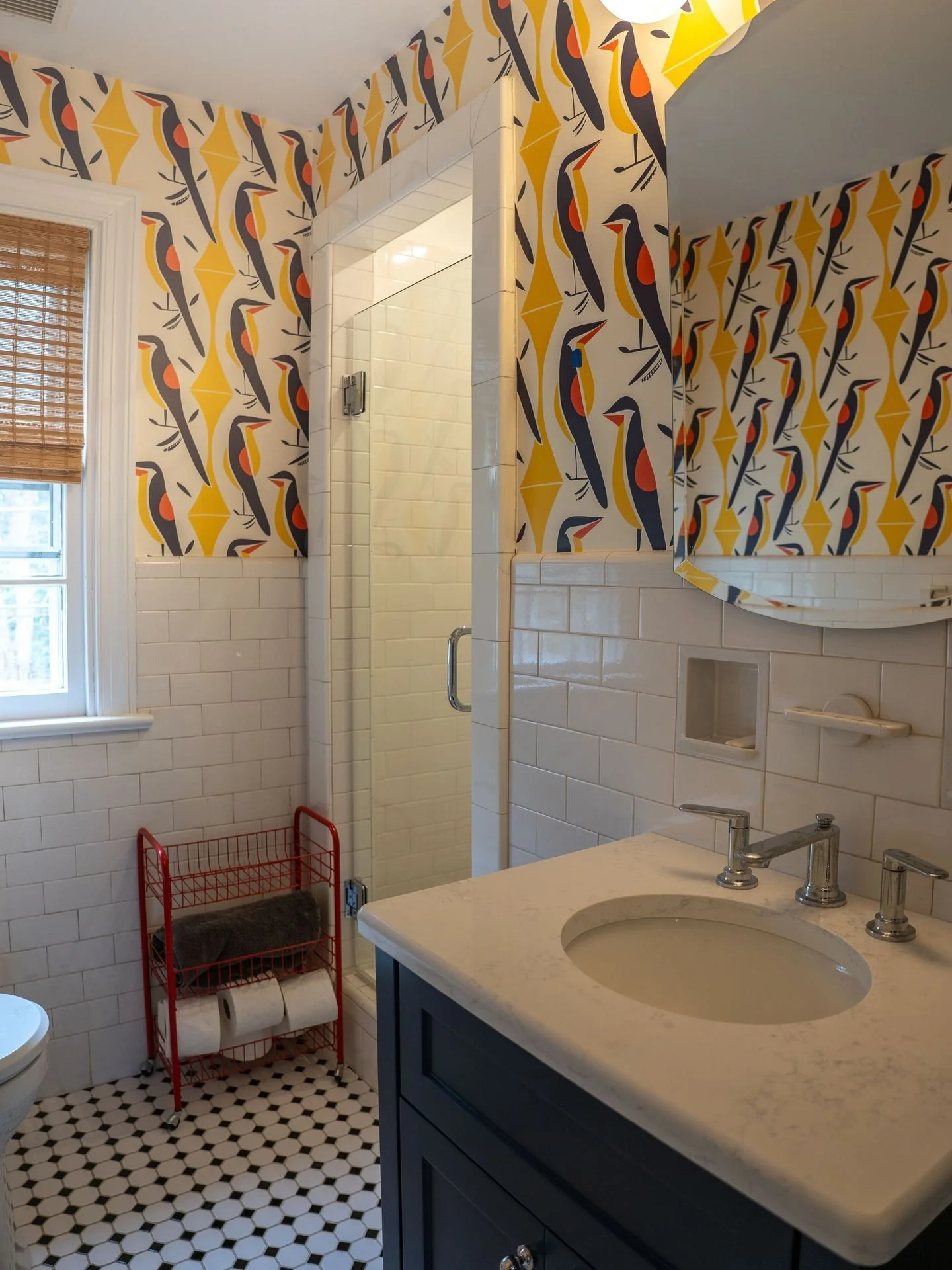 This bathroom renovation is giving us all the summer vibes we didn't know we needed ☀️ Bold bird wallpaper to compliment original crisp white subway tile and classic penny tile floors. 

Vanity built by @westchester.woodworks. 

Every finish was care
