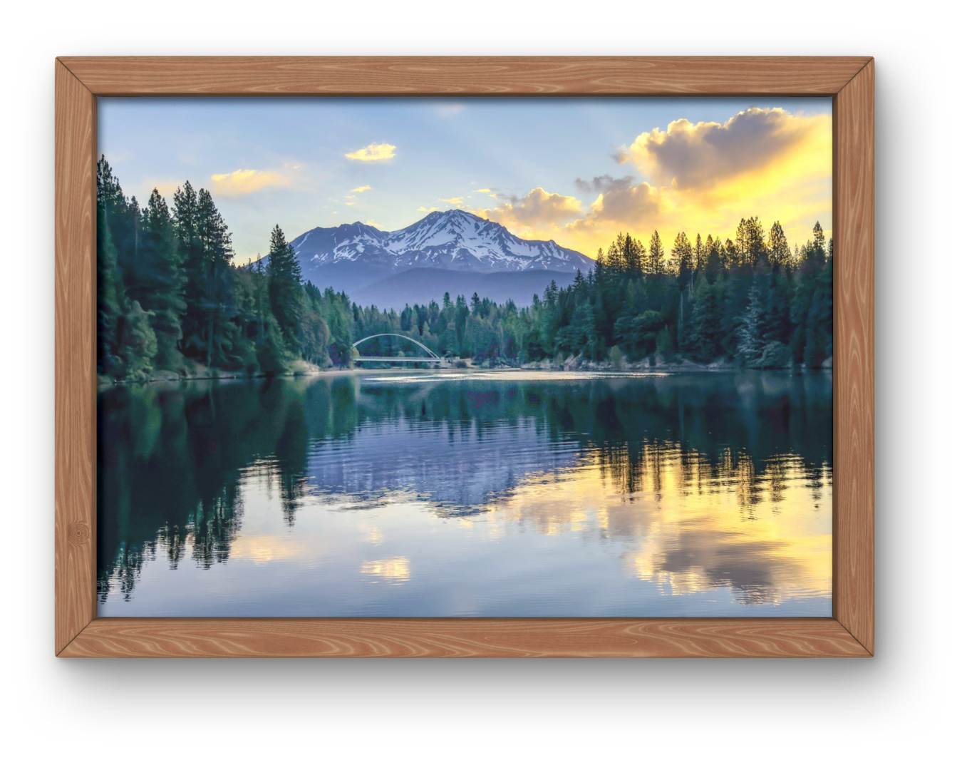 Framed landscape of a mountain, forest, and calm lake reflecting a soft golden sunset.