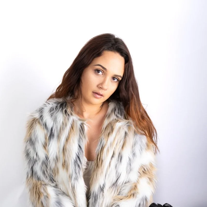 woman in a fux fur coat and brunette hair