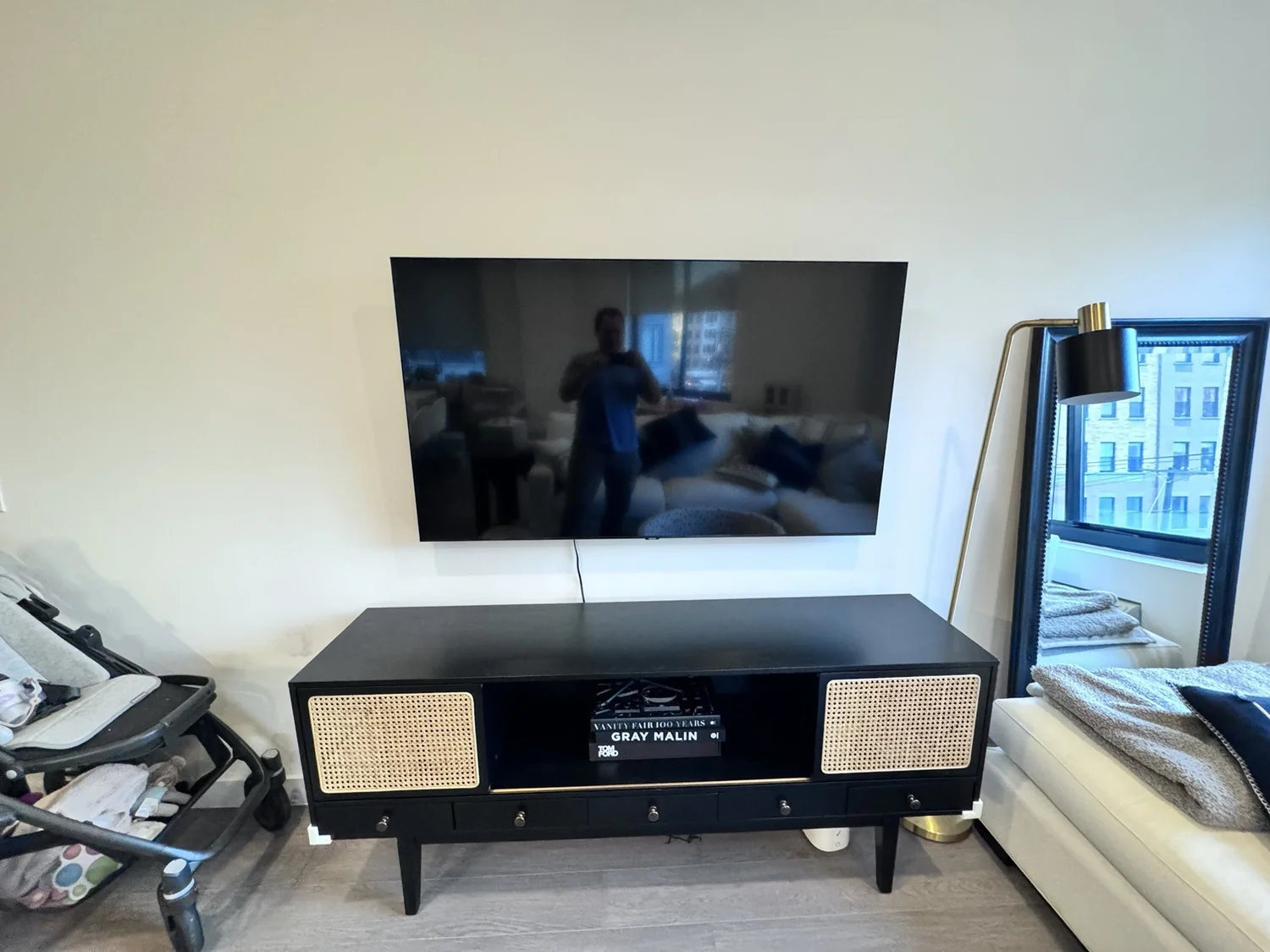 Large TV wall-mounted above a media console in a North Jersey living room