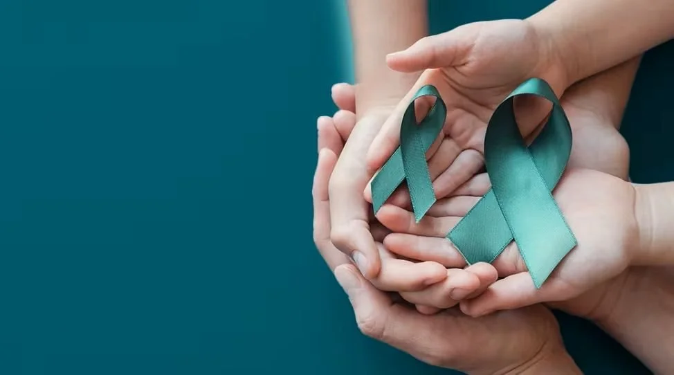 A teal awareness ribbon appears against a clean background as a simple visual symbol of support for survivors of sexual violence and commitment to prevention and education.
