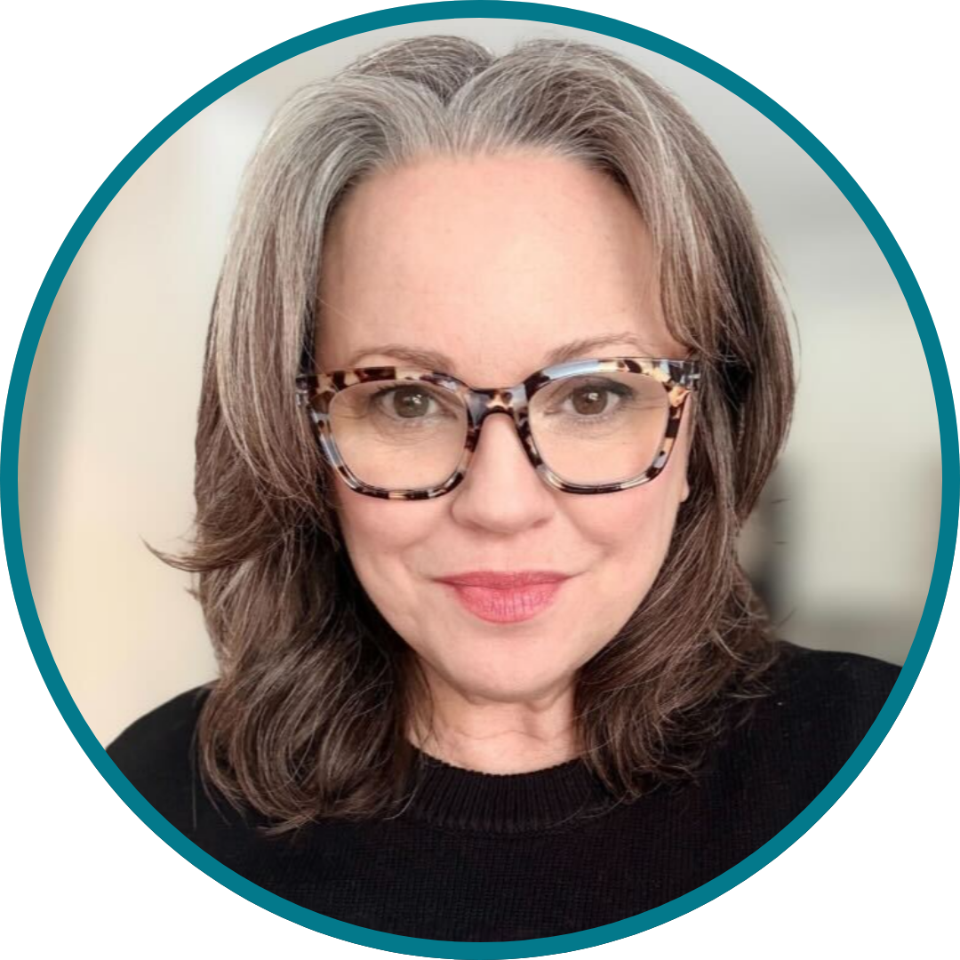 Headshot of Jess Michaels in black shirt and glasses