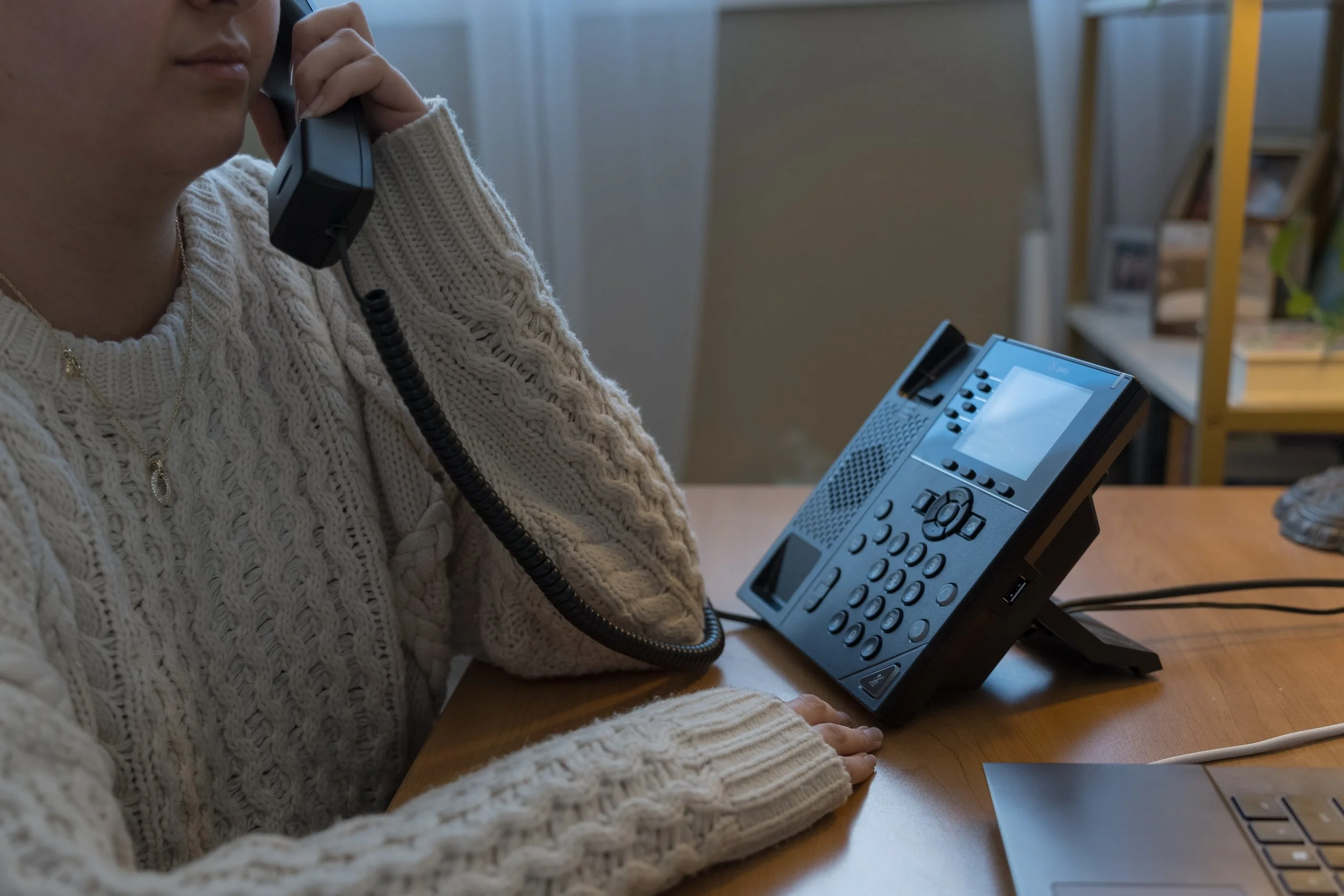 Overhead view of a hand-colored poster with the words “Listen Believe Support” in bright patterned lettering, set on a table with sheets of paper and a glass jar filled with crayons.