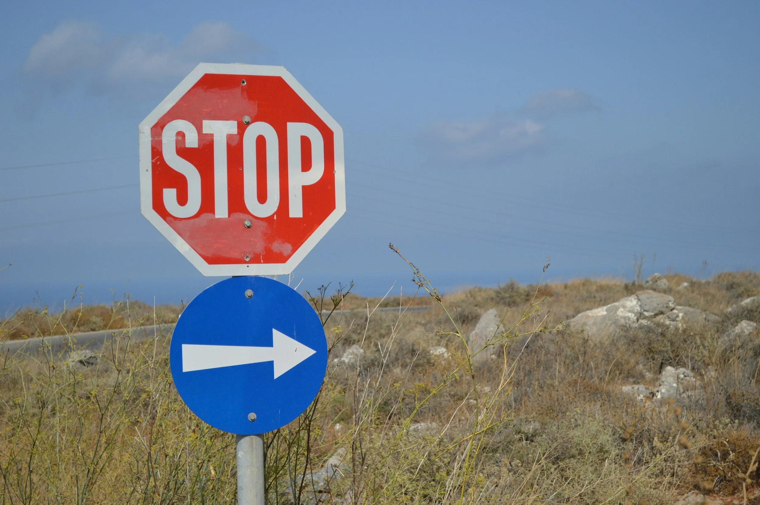 Stop sign with brown grass in the background