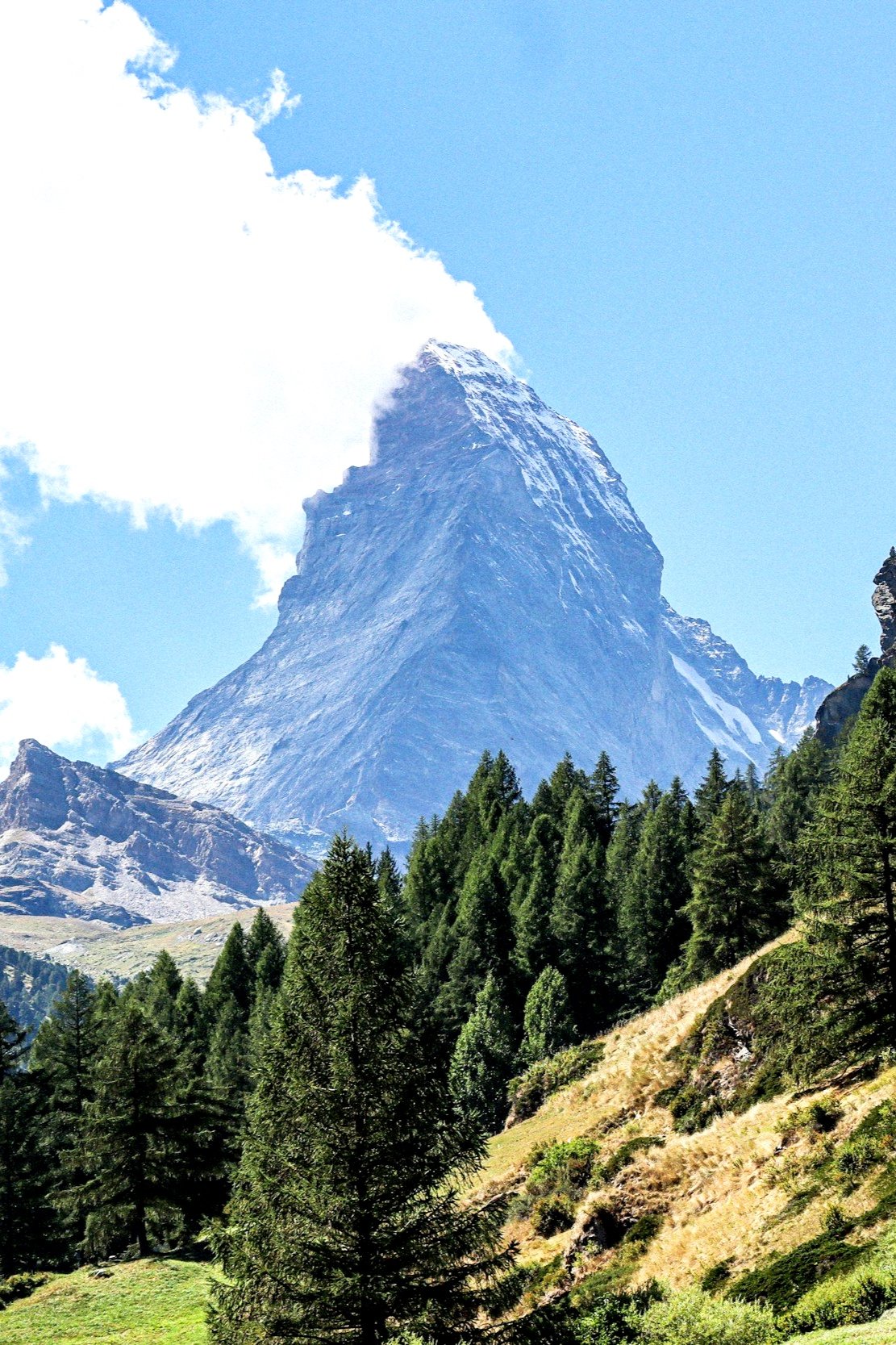 Stunning view of the Matterhorn, a majestic mountain in Switzerland, surrounded by pristine snow and clear blue skies, perfect for active adventures and luxury travel experiences.
