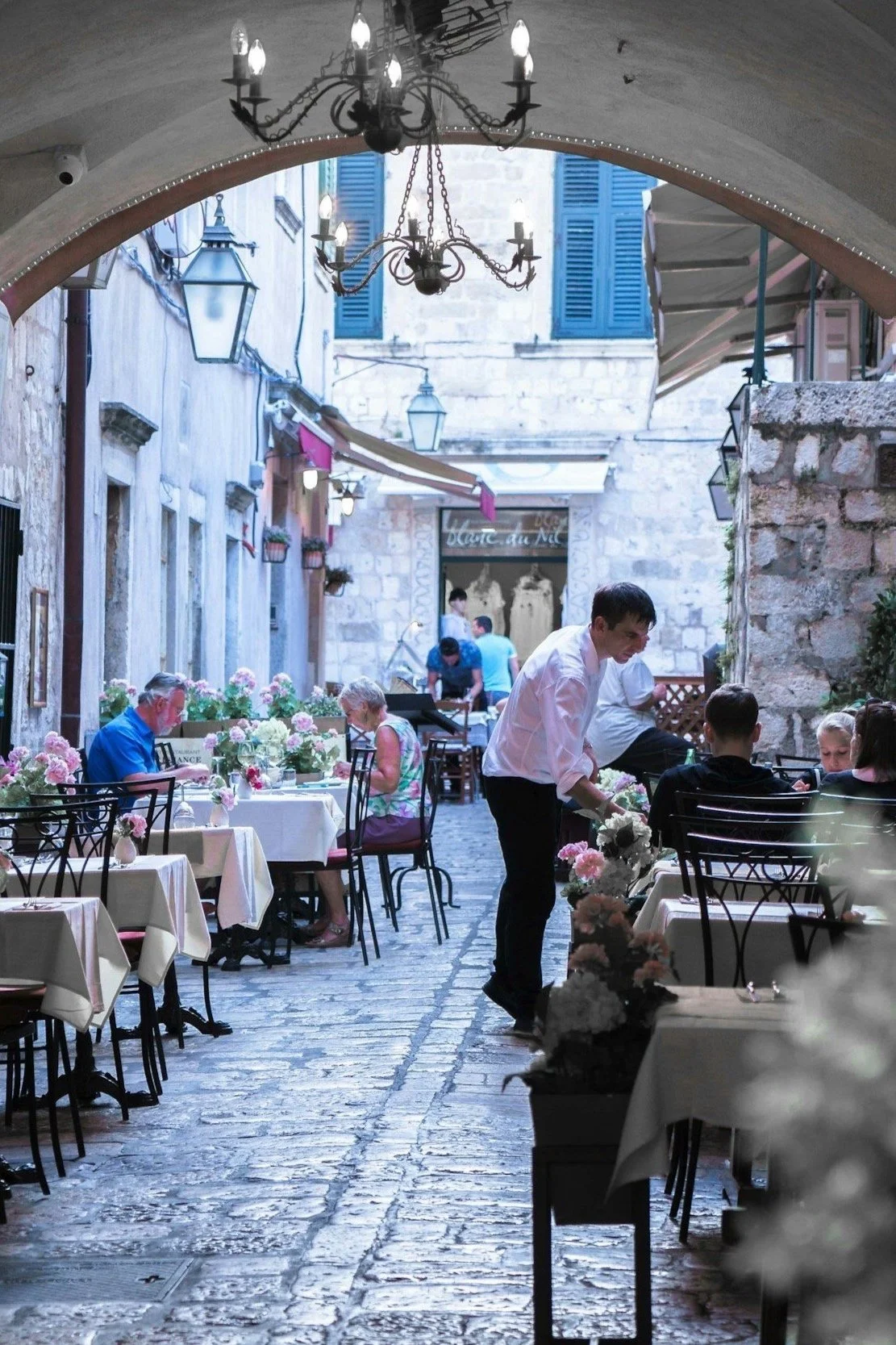 Travel in Dubrovnik, Croatia, showcasing exquisite dining at Michelin-starred restaurants. Scenic views of the historic city with elegant outdoor dining setups and gourmet dishes.