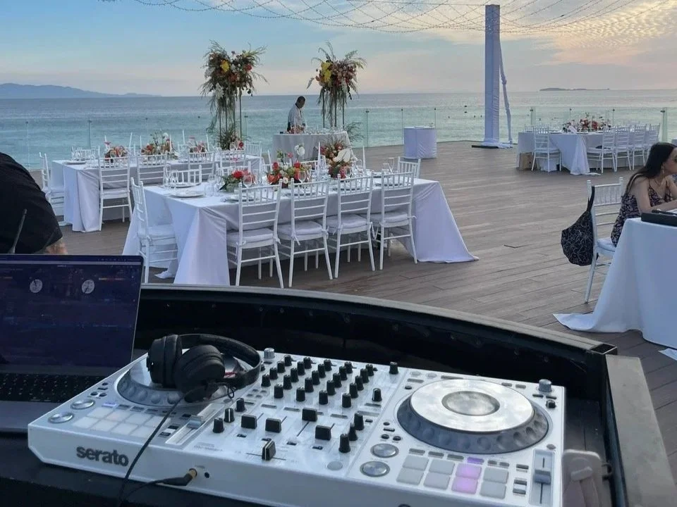 DJ set up at a beachside wedding with a stylish white controller