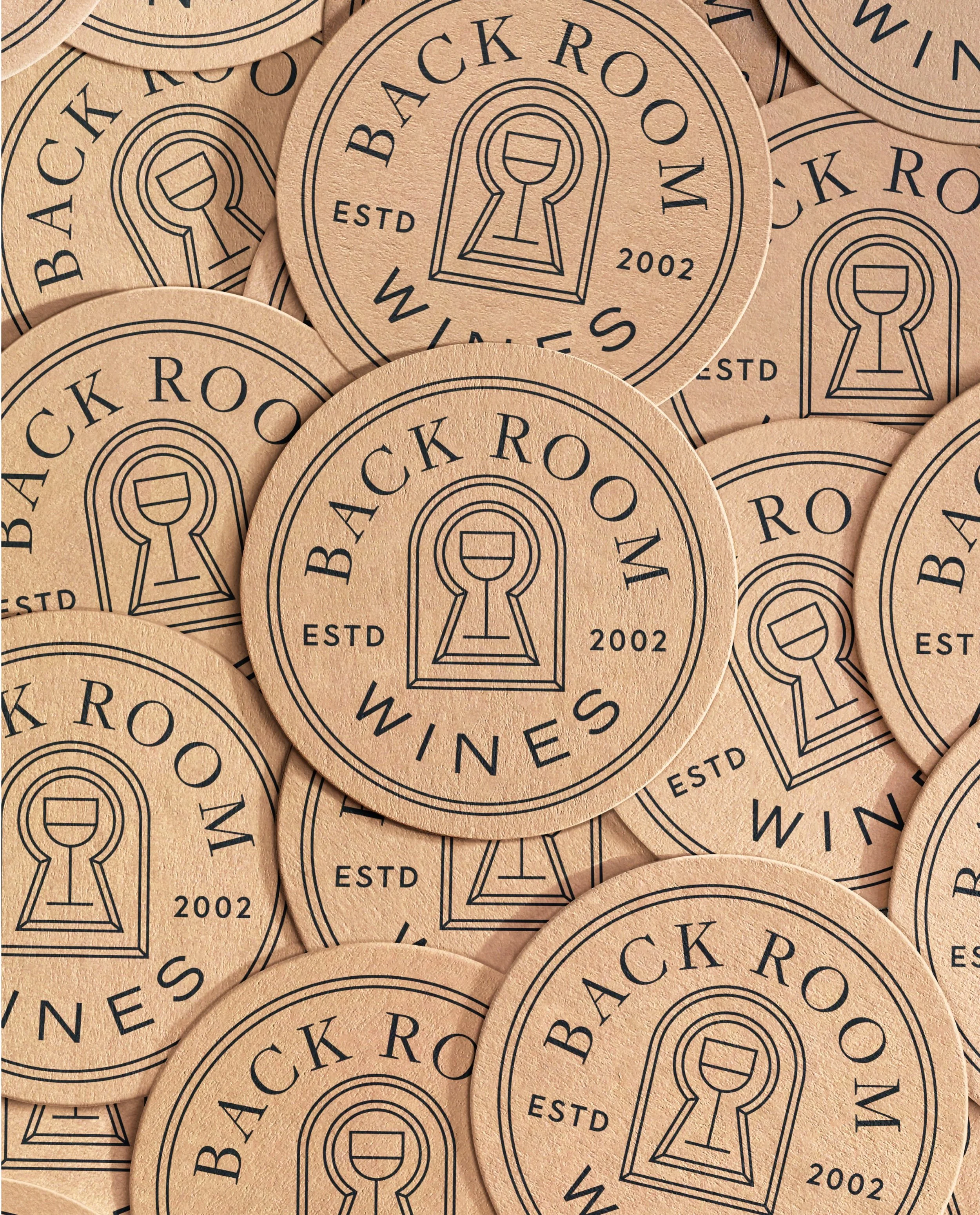 From coasters and business cards to signage, the @backroomwines identity was designed to adapt across every application. Different elements of the logo system take shape across each touchpoint, creating variety while keeping the brand cohesive.