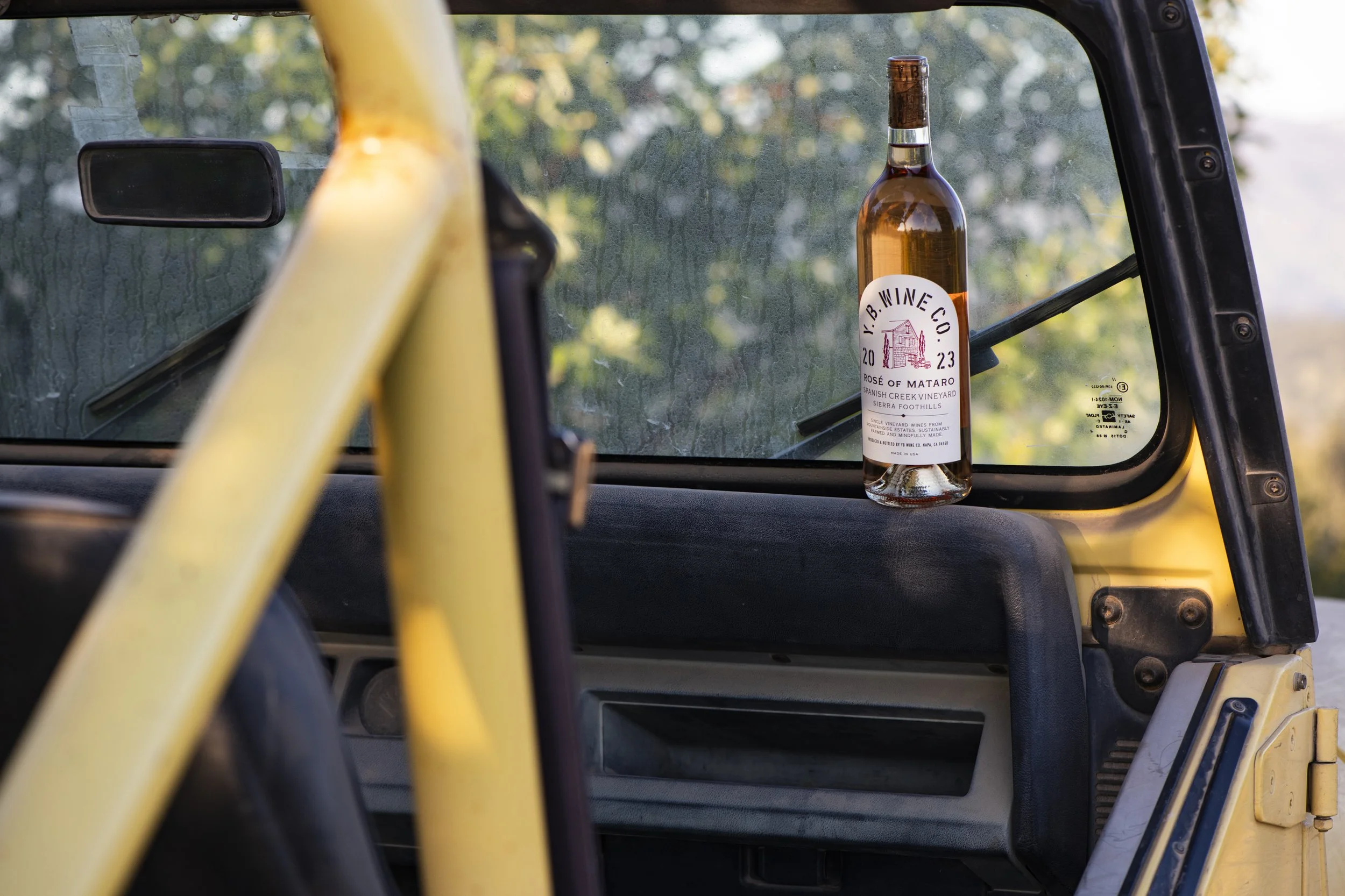 YB Wine Co Mount Veeder Napa Valley Rose bottle sitting in vintage jeep