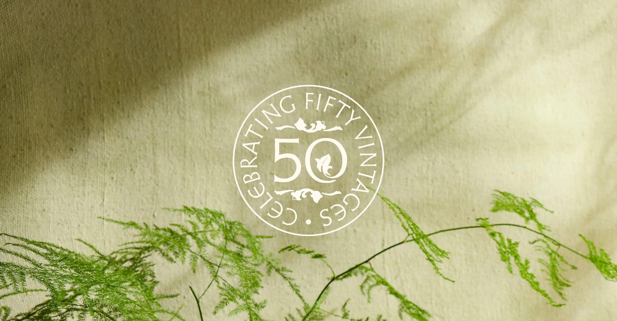 Mount Veeder Winery Napa Valley Cabernet Sauvignon anniversary seal in front of green background