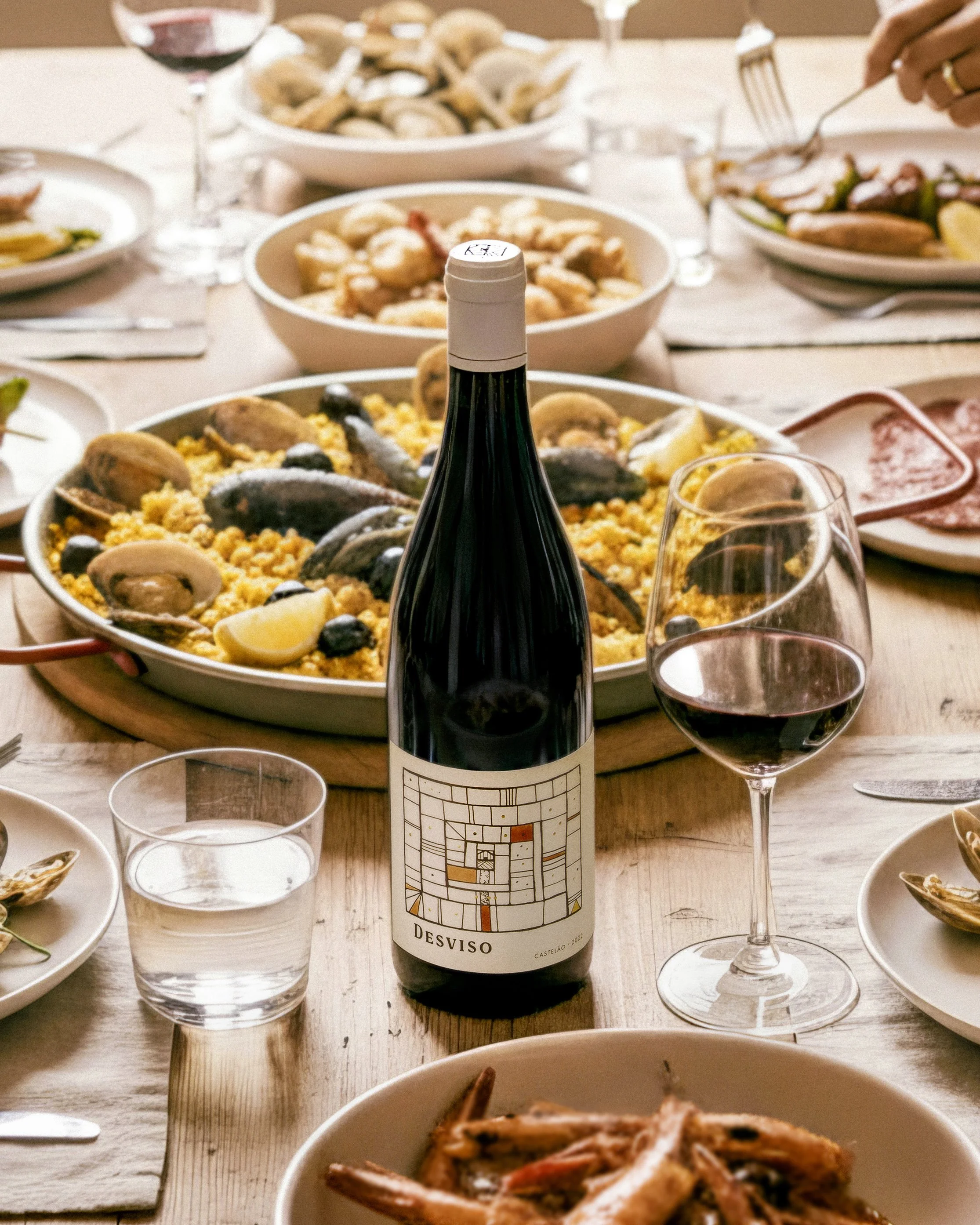 Desviso wines Castelao label featured on dinner table with seafood in backgound