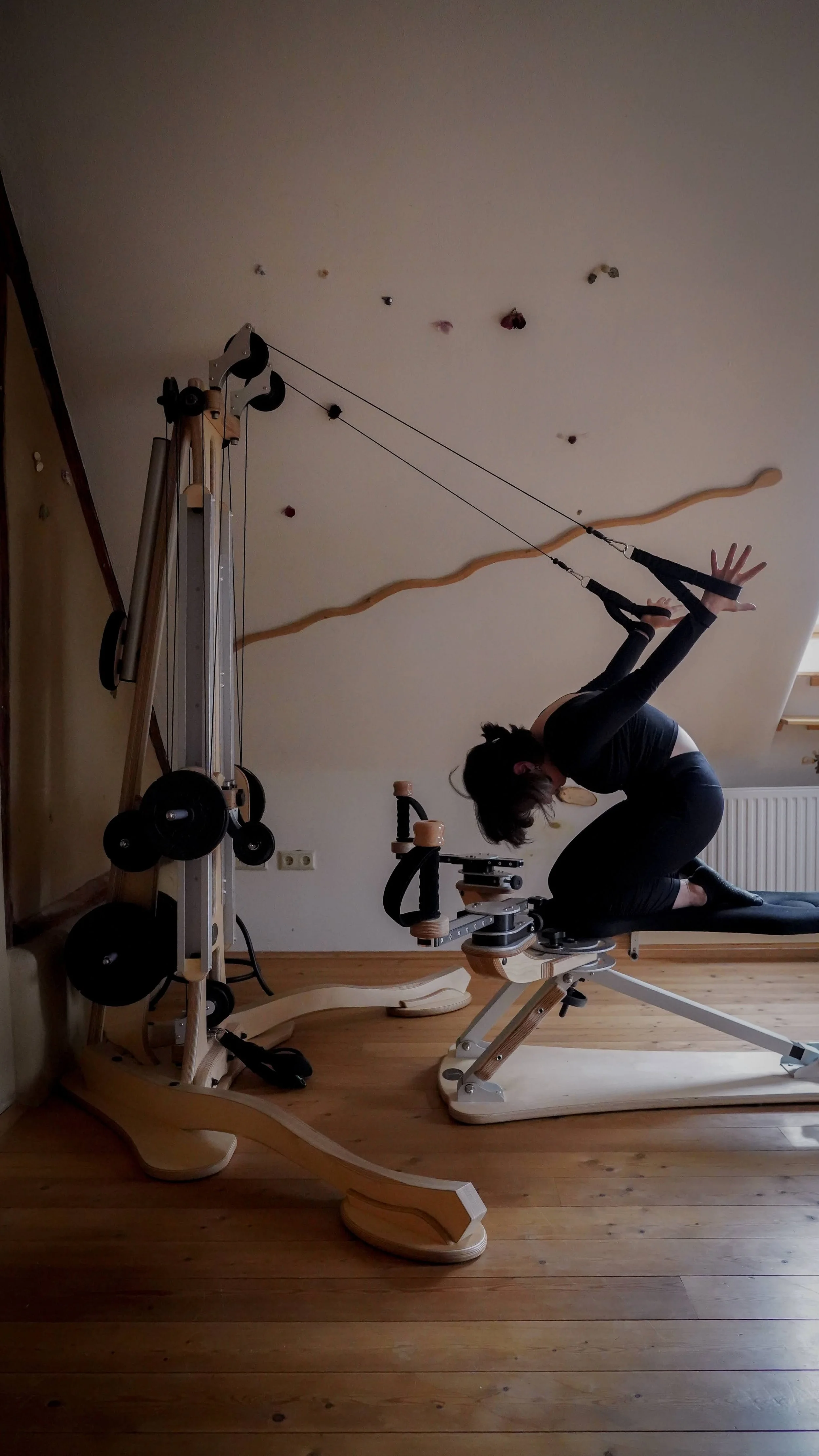 Trainer performing Gytotonic exercise on a pully tower machine