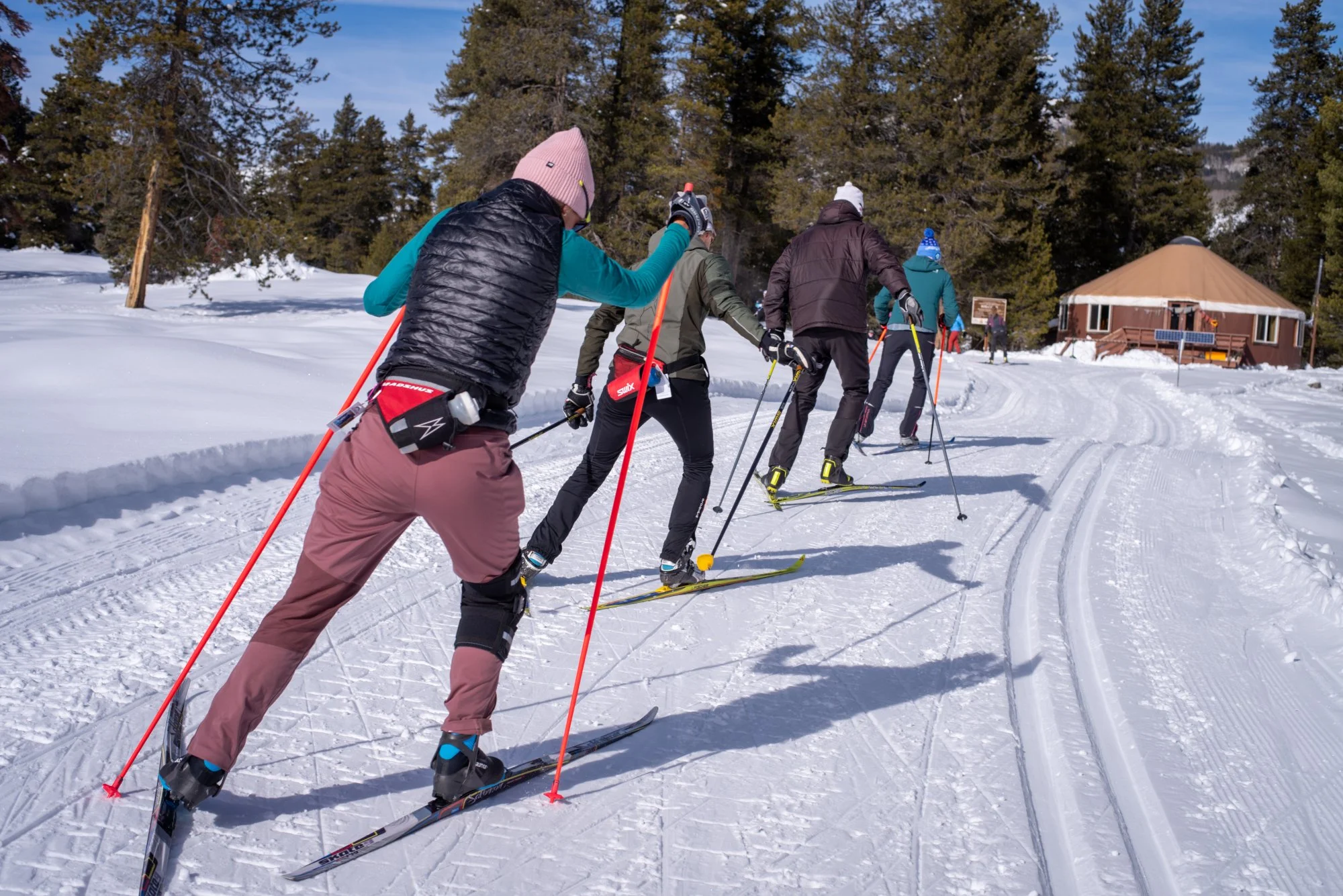 masters skiers ski out by the magic meadows yurt