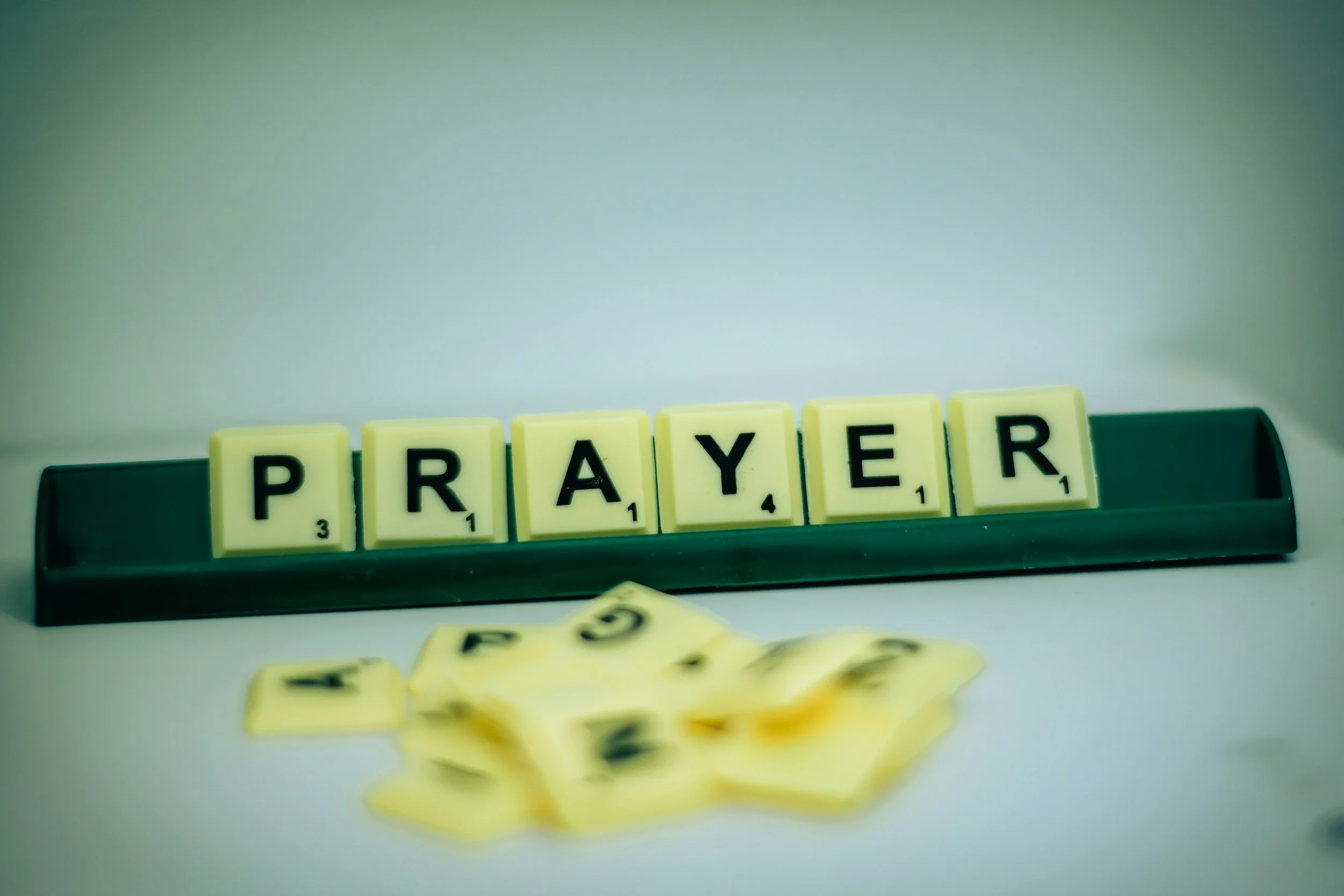 Purposeful Living prayer and meditation graphic showing a woman praying quietly in a sunlit forest.