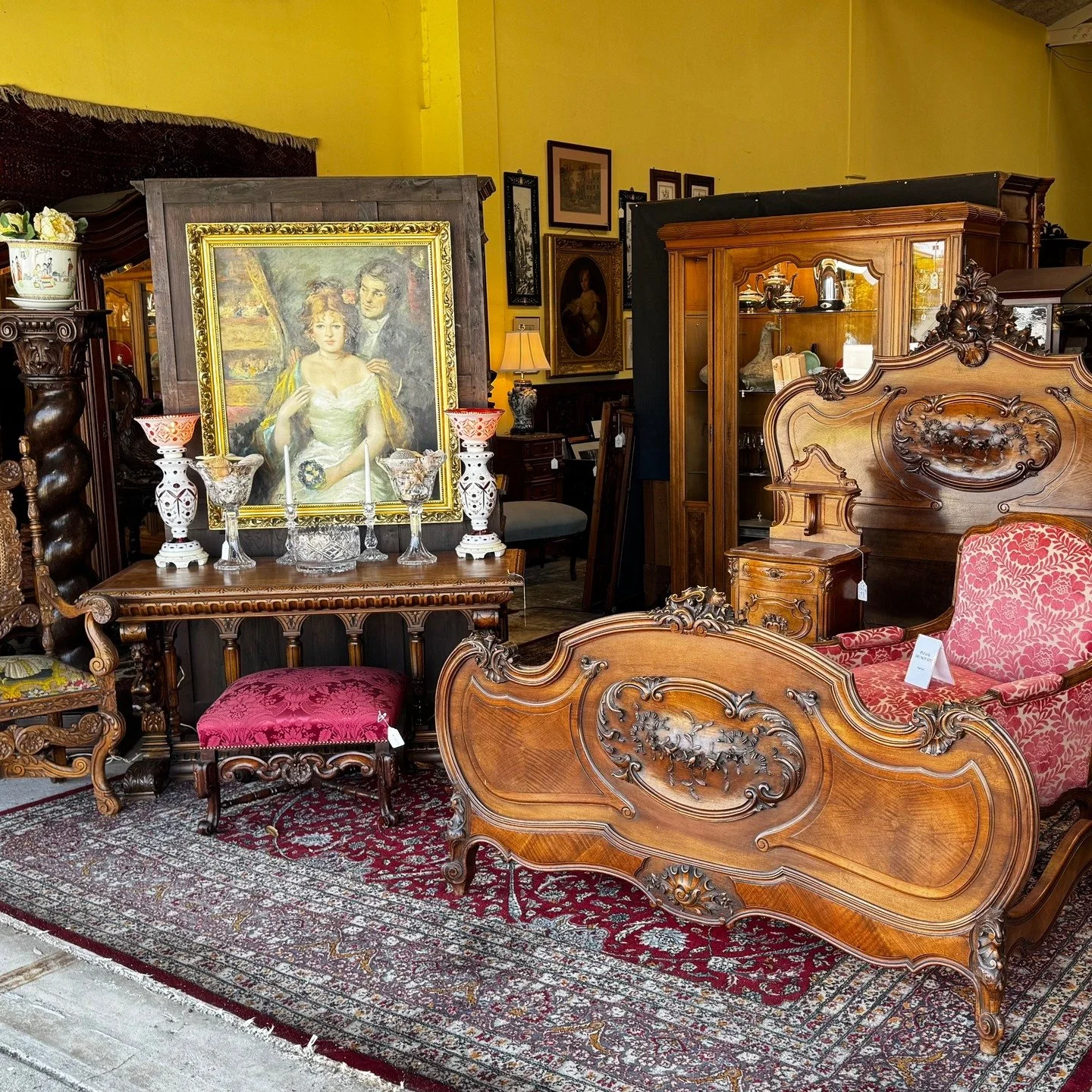 Our new storefront display is up! Come take a look at a beautiful Walnut French Louis XV style bed with matching nightstand, an eye-catching Italian Renaissance Revival center table, a tall oak column, and a classic Dutch oak stool. Just a few of the
