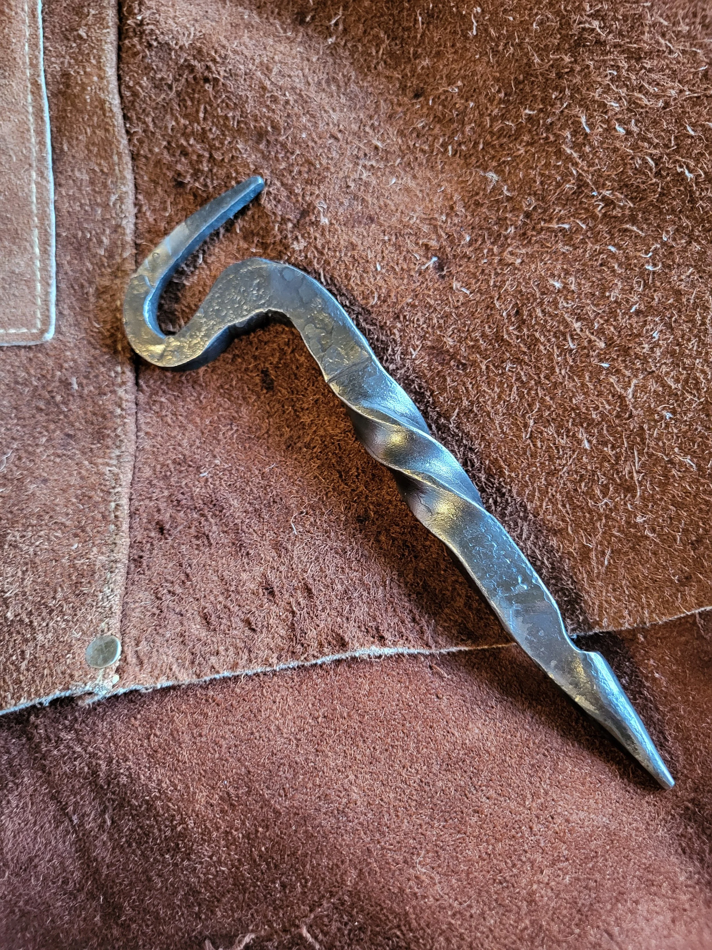 Hand forged bottle opener with spiked end