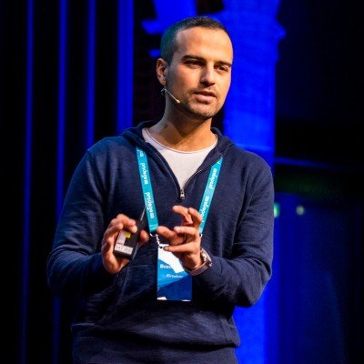 Amir Bozorgzadeh, CEO of Virtuleap giving a presentation on stage at a tech conference.