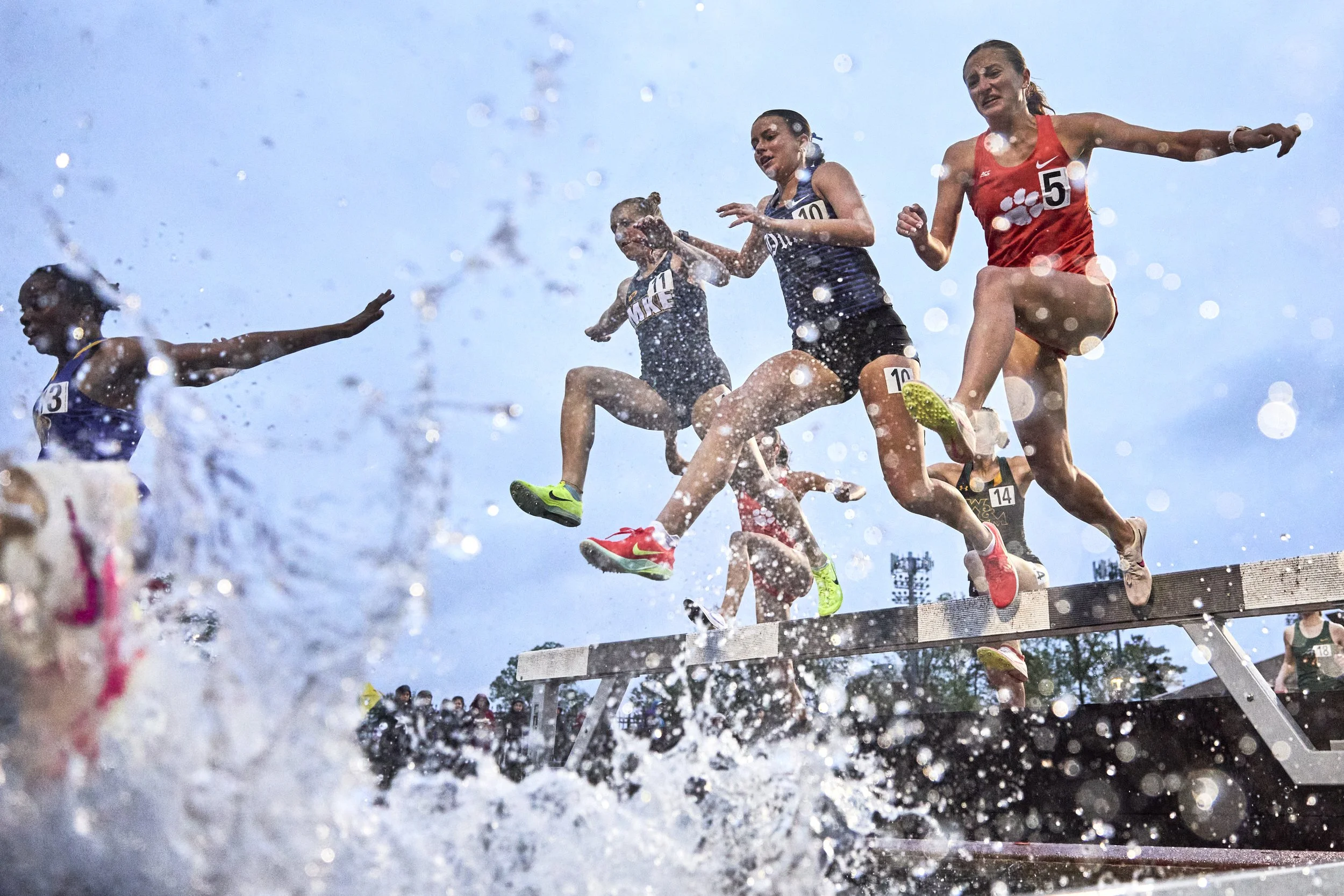 From left, Cailin Kinas of Minnesota, Grace Geyer of Duke, and Madelyn Dinnen of Clemson jump over the water barrier during the women's 3,000-meter steeplechase event at the Duke Invitational at Morris Williams Stadium on Friday, April 11, 2025, in D