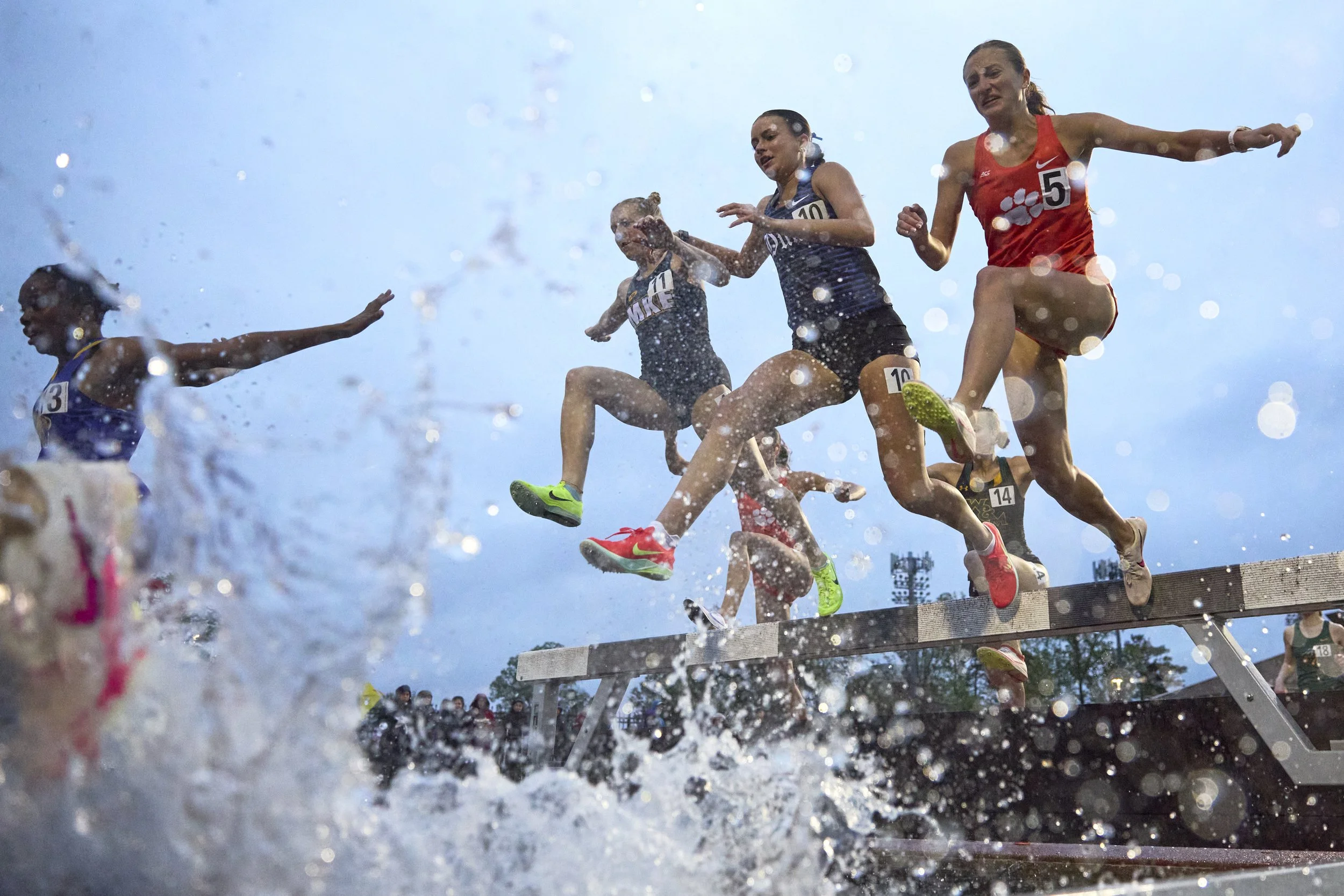 From left to right, Cailin Kinas of Minnesota, Grace Geyer of Duke, and Madelyn Dinnen of Clemson jump over the water barrier during the women’s 3,000m steeplechase event at the Duke Invitational at Morris Williams Stadium on Friday, April 11, 2025 i