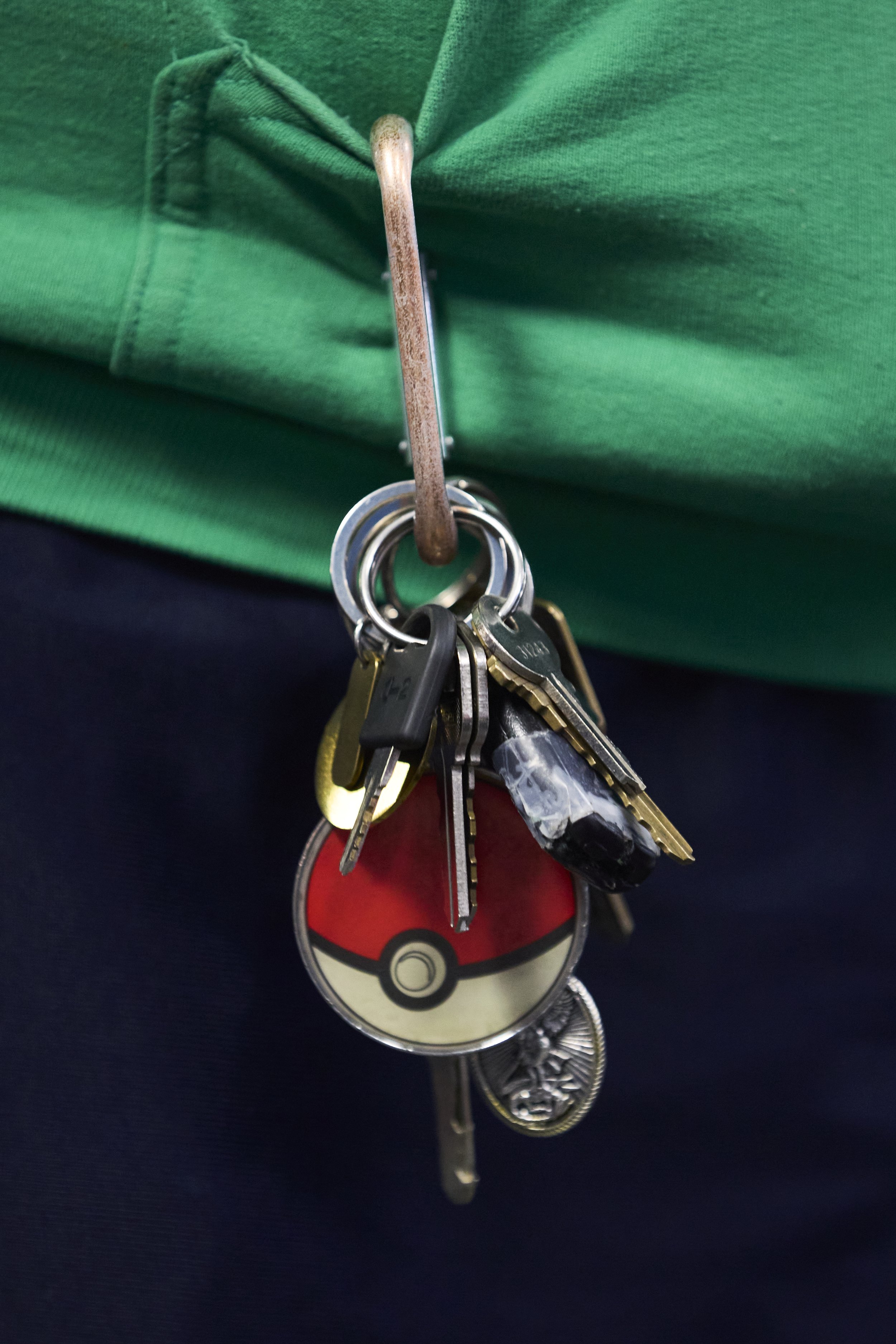 A regular at Deep Dive Games wears a Pokémon ball on his keychain. 