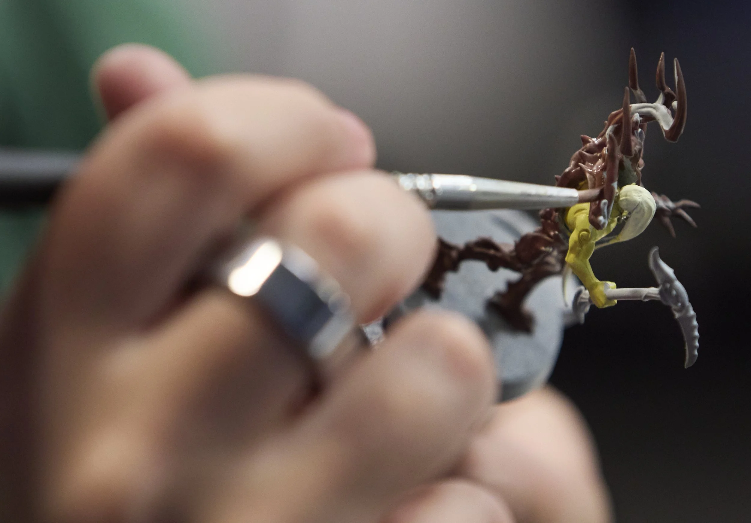 Savannah Smith paints a Warhammer figure that is used to play the game at Deep Dive Games on Nov 5, 2025, in Athens, Ohio.