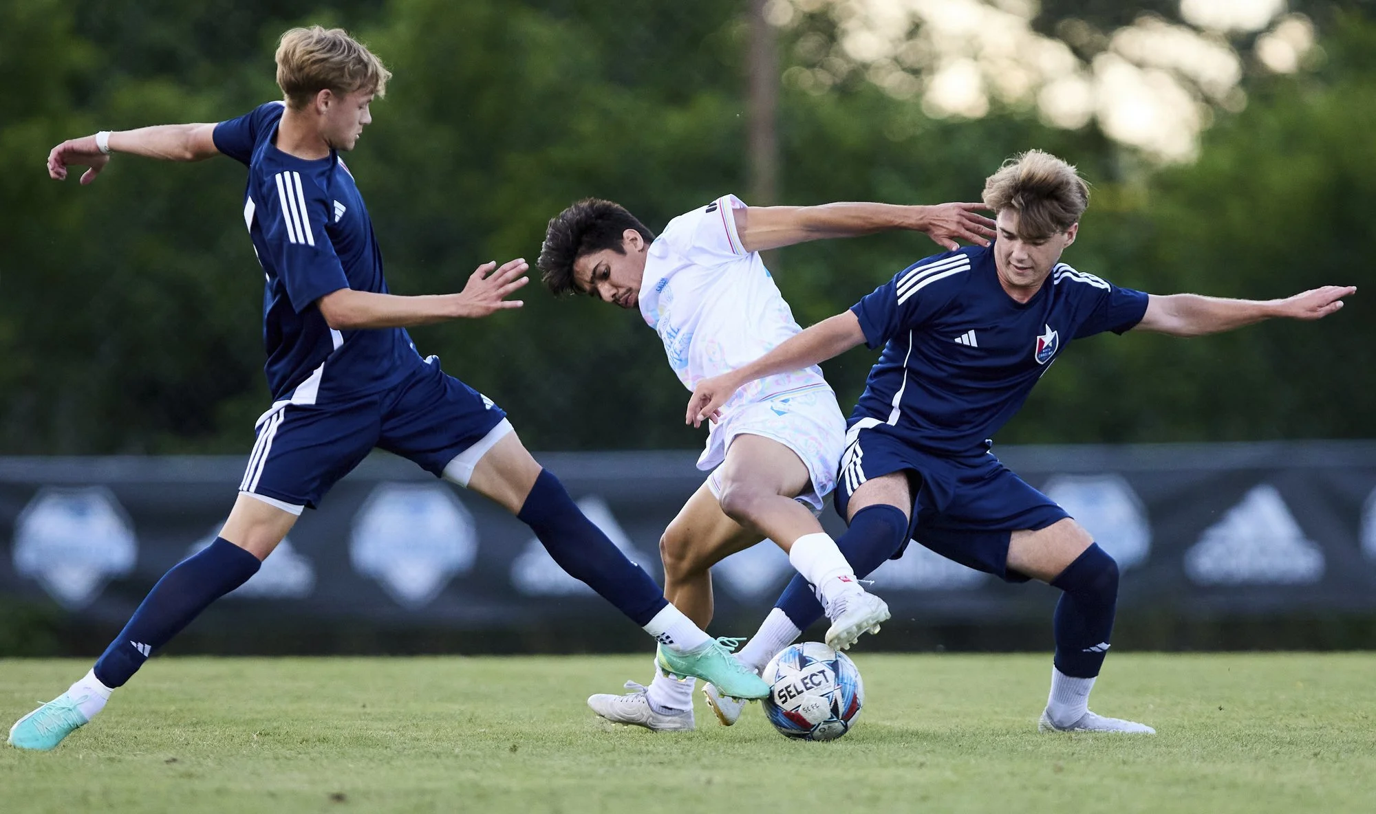 Guilherme Fontes (16) of Salem F.C. dribbles into two North Carolina F.C. defenders on May 29, 2023 at Truist Stadium in Winston-Salem, NC.