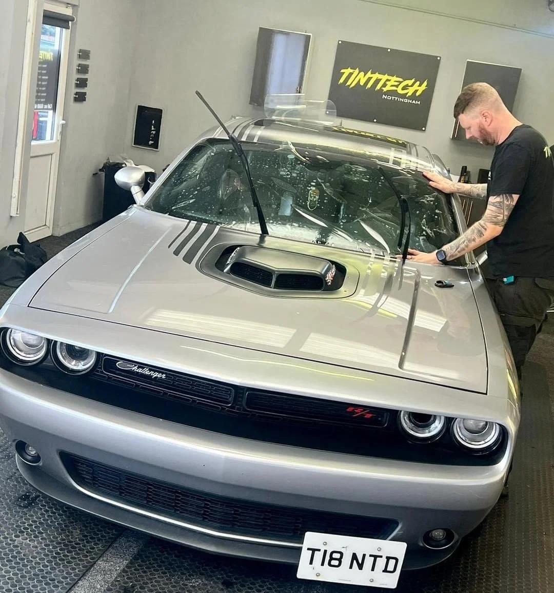 Dodge Challenger having windscreen film fitted by hand inside the TintTech Nottingham studio
