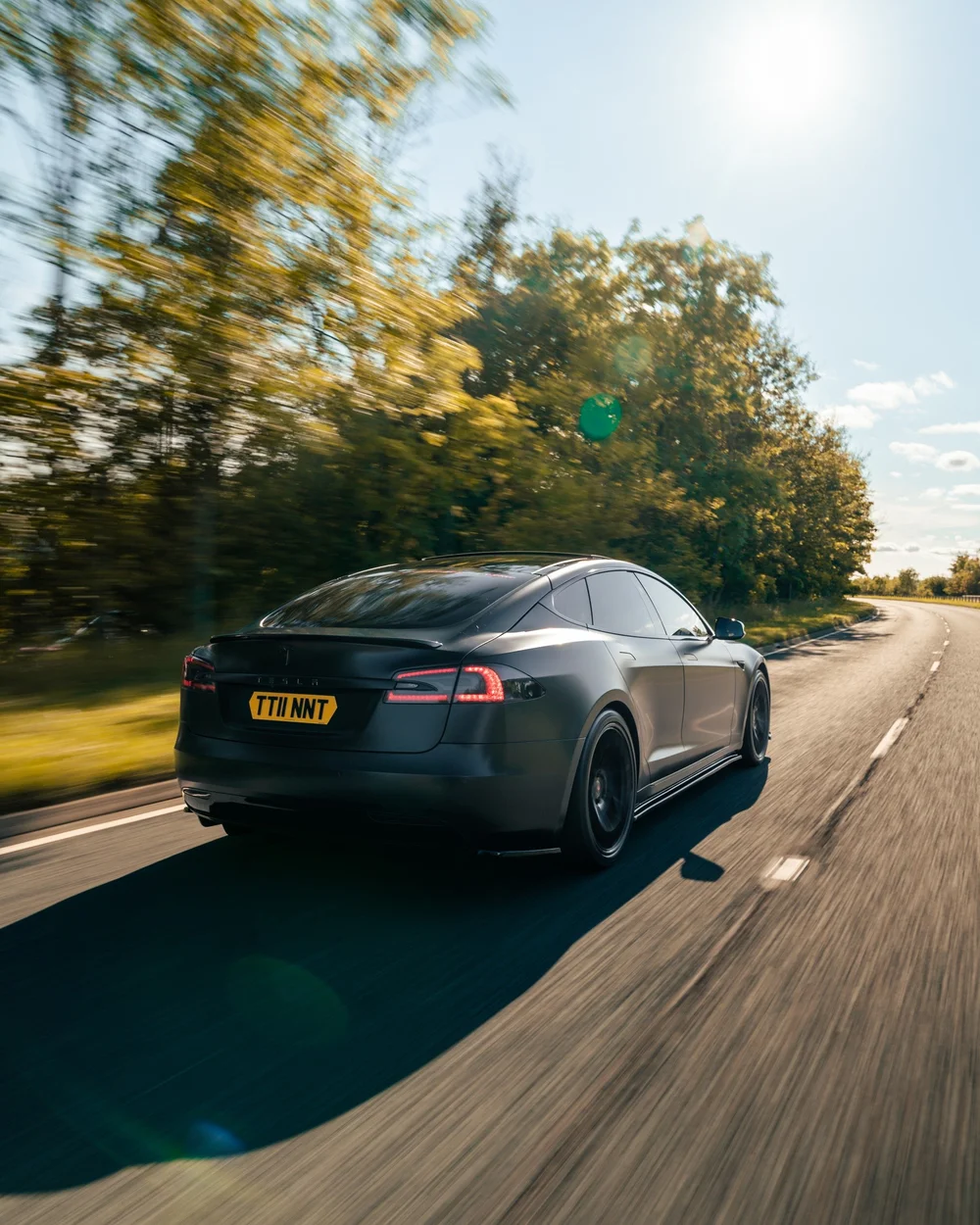 Satin black wrapped Tesla Model S on the road