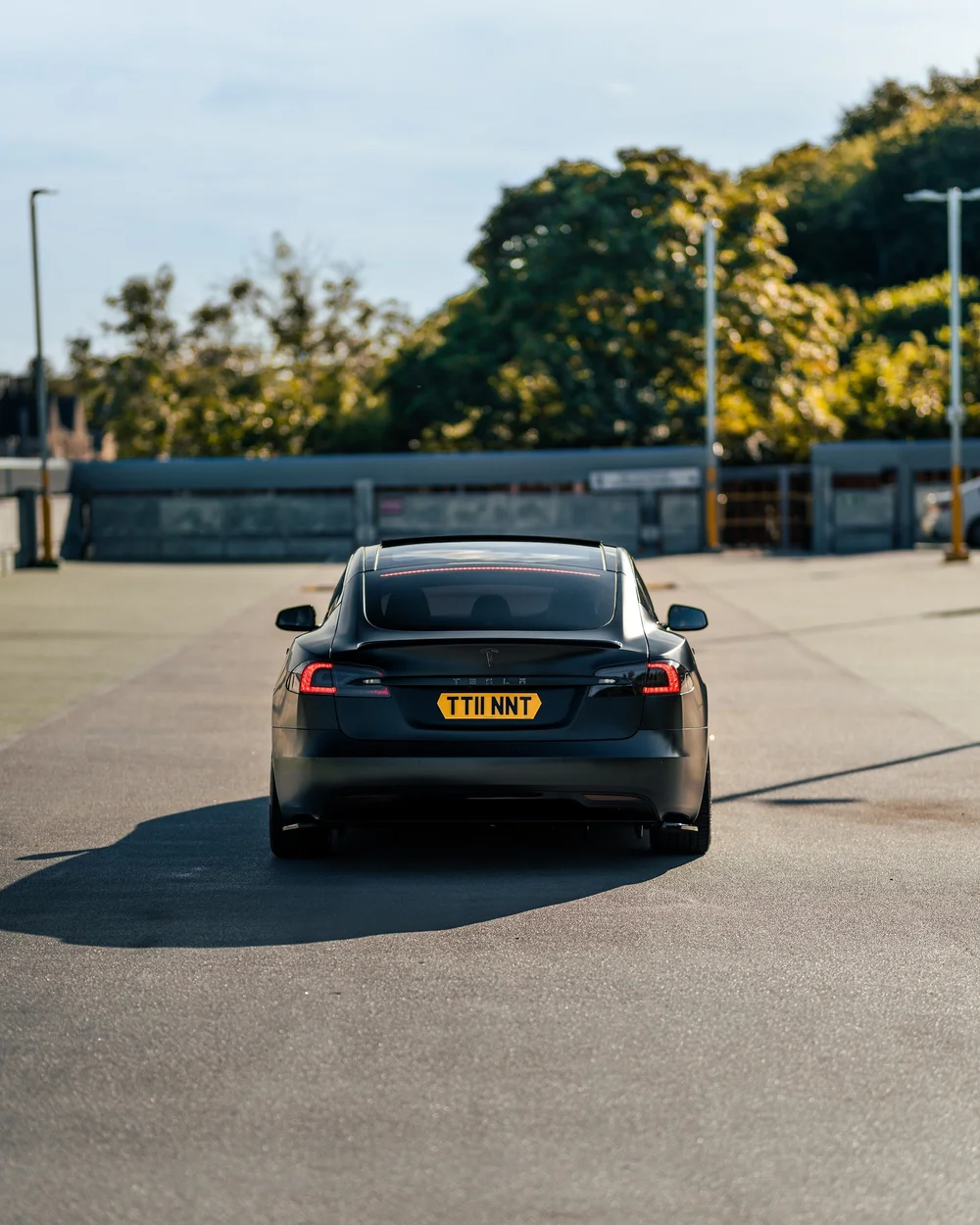 Rear view of a satin black full colour change wrap on a Tesla Model S