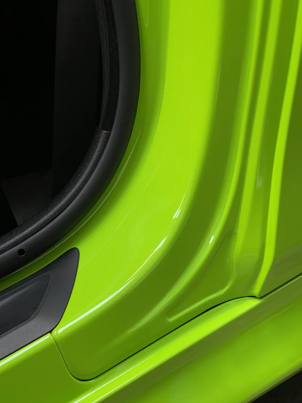 Close up of an acid green gloss vinyl wrap finish
