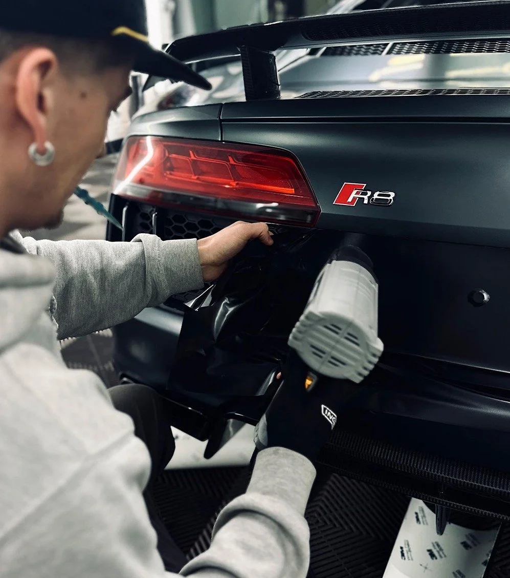 Audi R8 being wrapped in satin black vinyl by TintTech
