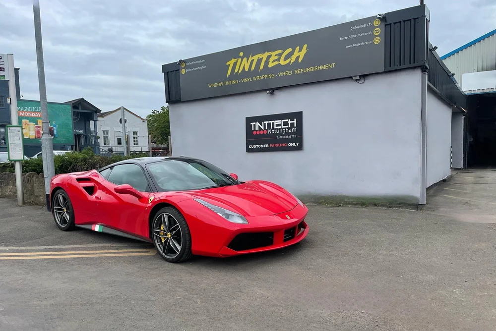Red Ferrari in the customer parking outside the TintTech Nottingham unit on Churchfield Court