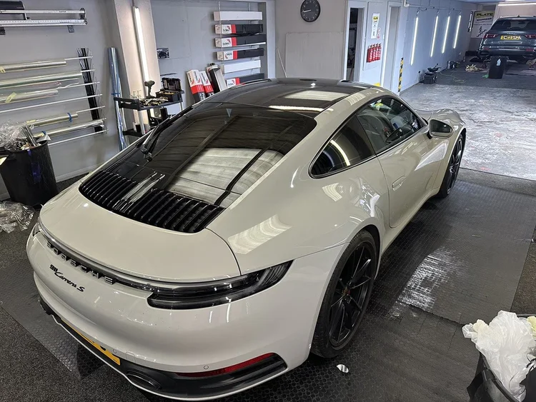 White Porsche 911 with tinted windows in the TintTech Nottingham studio