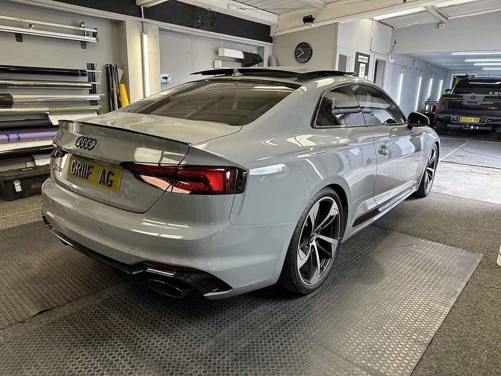 Silver Audi coupe with tinted lights inside the TintTech Nottingham workshop
