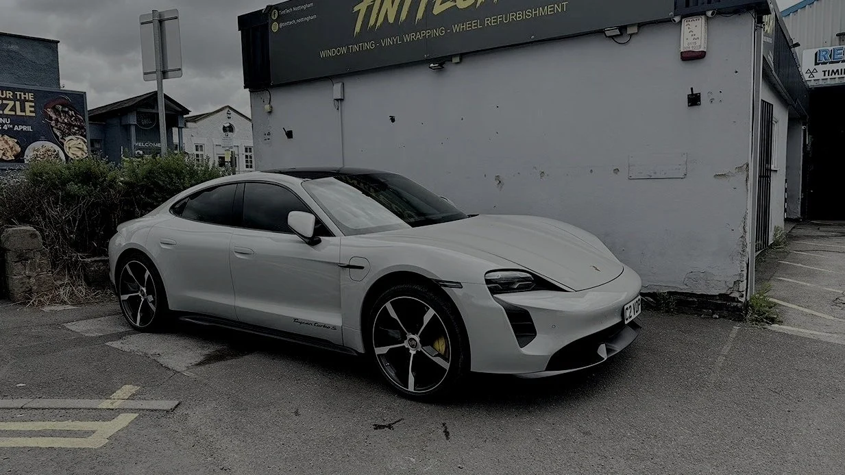 White Porsche Taycan parked outside the TintTech Nottingham unit