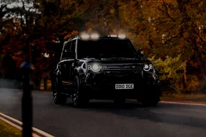 Black Land Rover Defender with a body kit