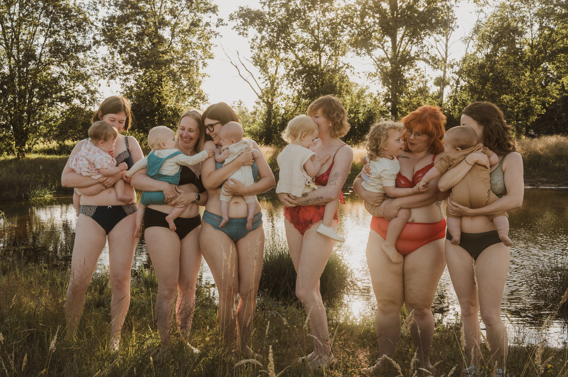 zes mama's en kindjes samen in de natuur, ze lachen naar elkaar