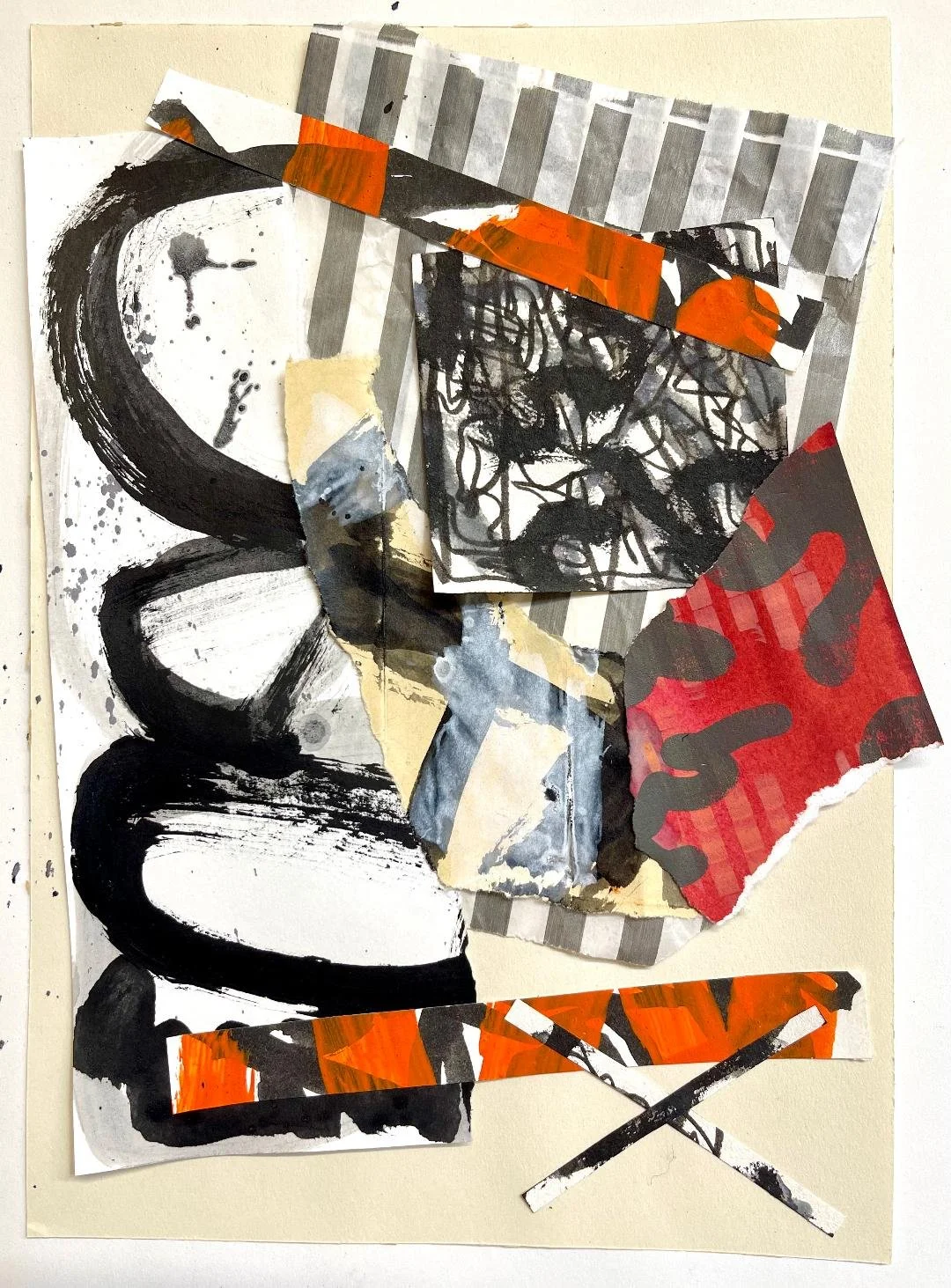Mixed media collage featuring torn paper, black abstract brushstrokes, red and orange patterned paper, and striped elements arranged in an abstract composition on a white background.