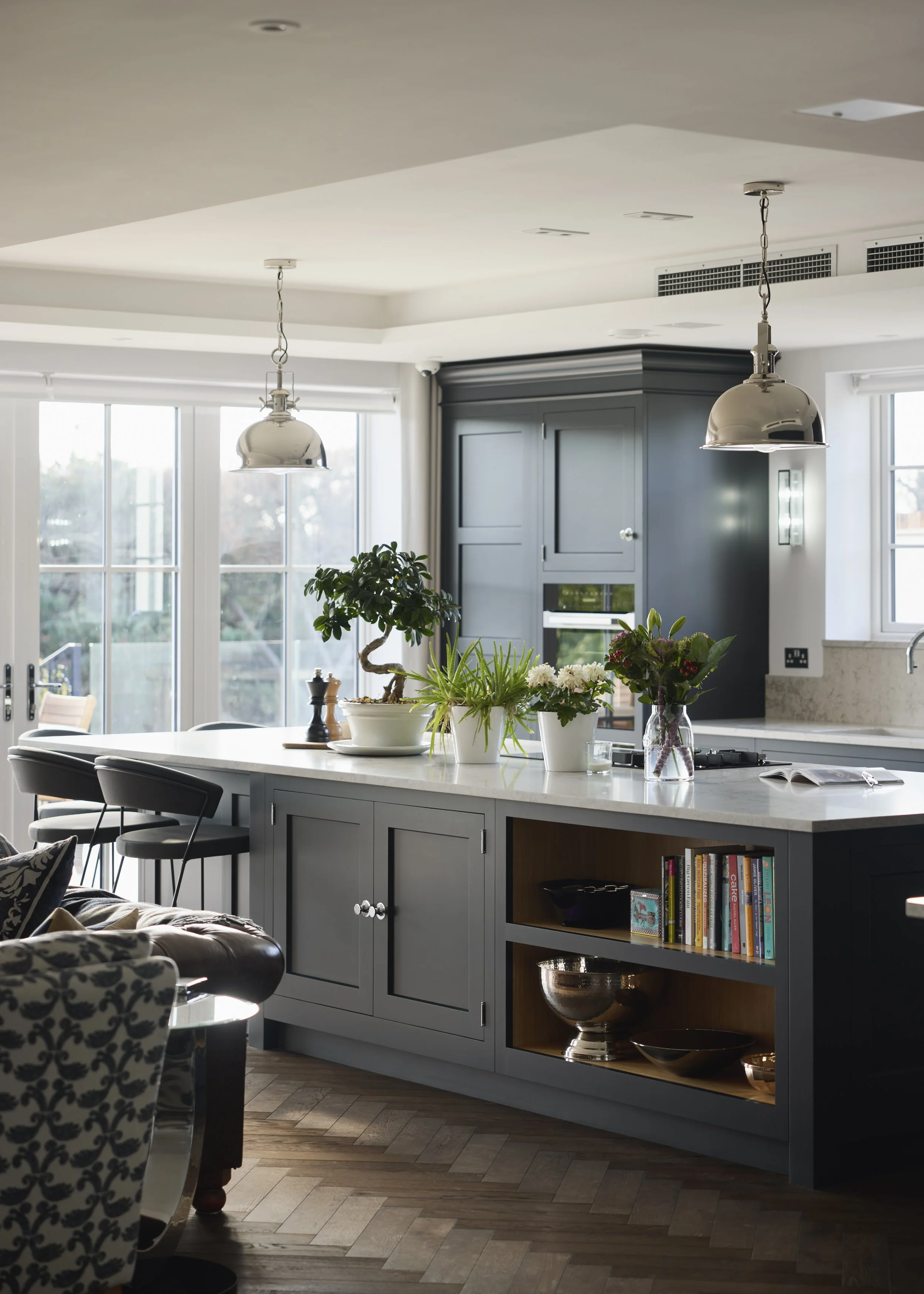 Contemporary kitchen at Over Links with dark cabinetry, large island, and pendant lights
