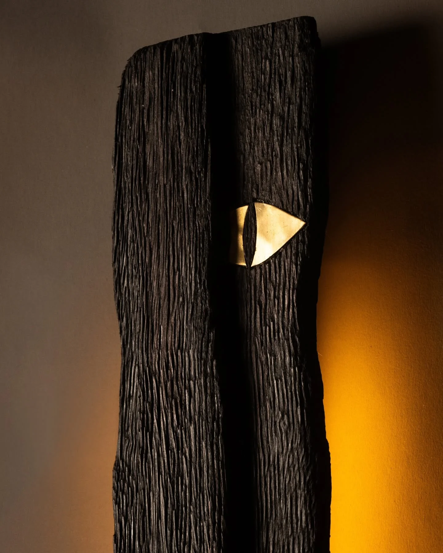 Drushti Deepa from Nidra Collection 
A shard of charred timber glows from within, pierced by inlays of brass; like silent watchers of the night.
Shot by @hansoga_photography
#TheVernacularModern #NidraCollection #LightingDesign #ReclaimedWood #Arti