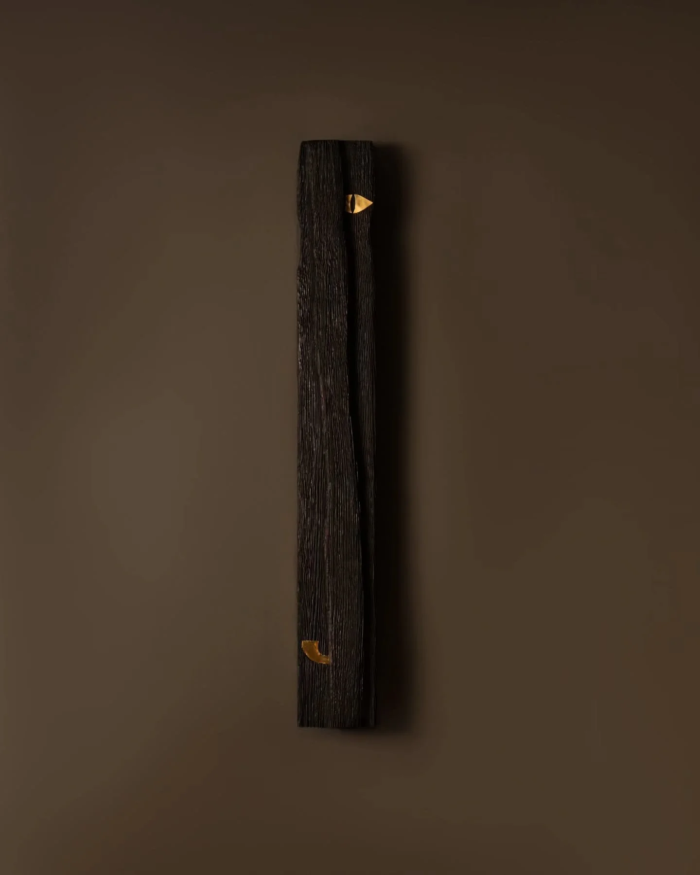 Drushti Deepa from Nidra Collection 
A shard of charred timber glows from within, pierced by inlays of brass; like silent watchers of the night.
Shot by @hansoga_photography
#TheVernacularModern #NidraCollection #LightingDesign #ReclaimedWood #Arti