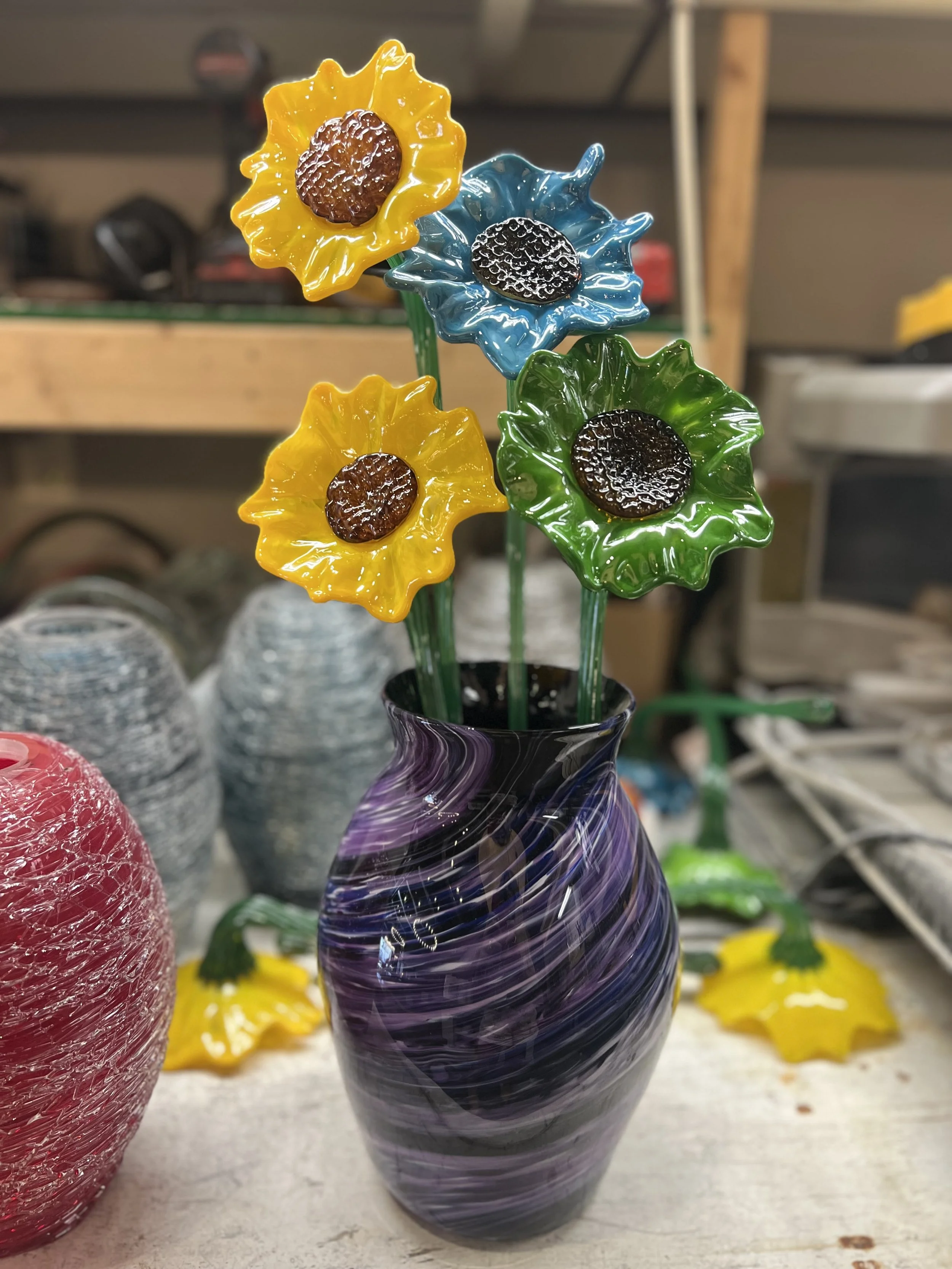 Colorful glass flowers in a vase.