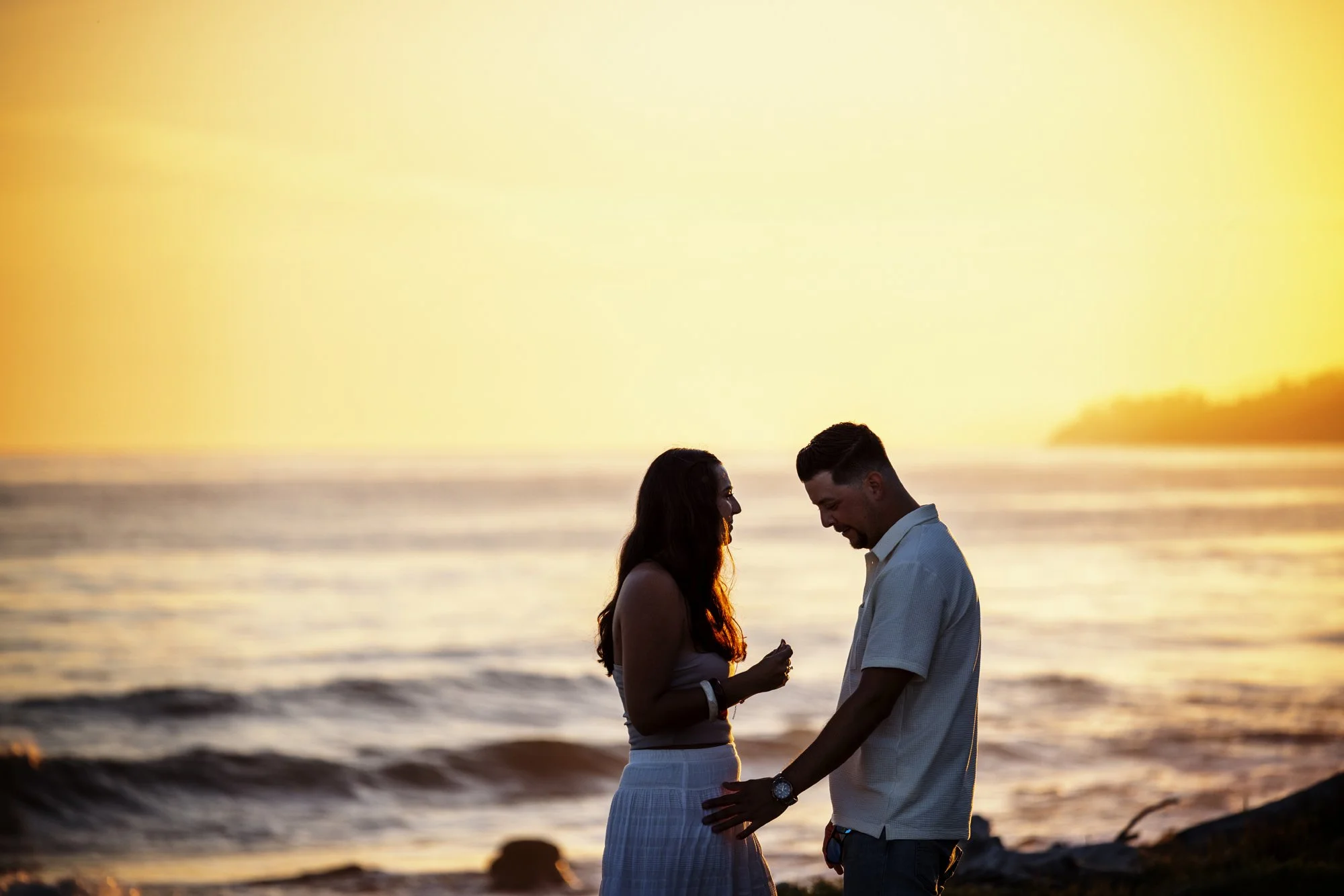 Newly engaged couple celebrating after a sunset proposal on the beach along the Gaviota Coast.