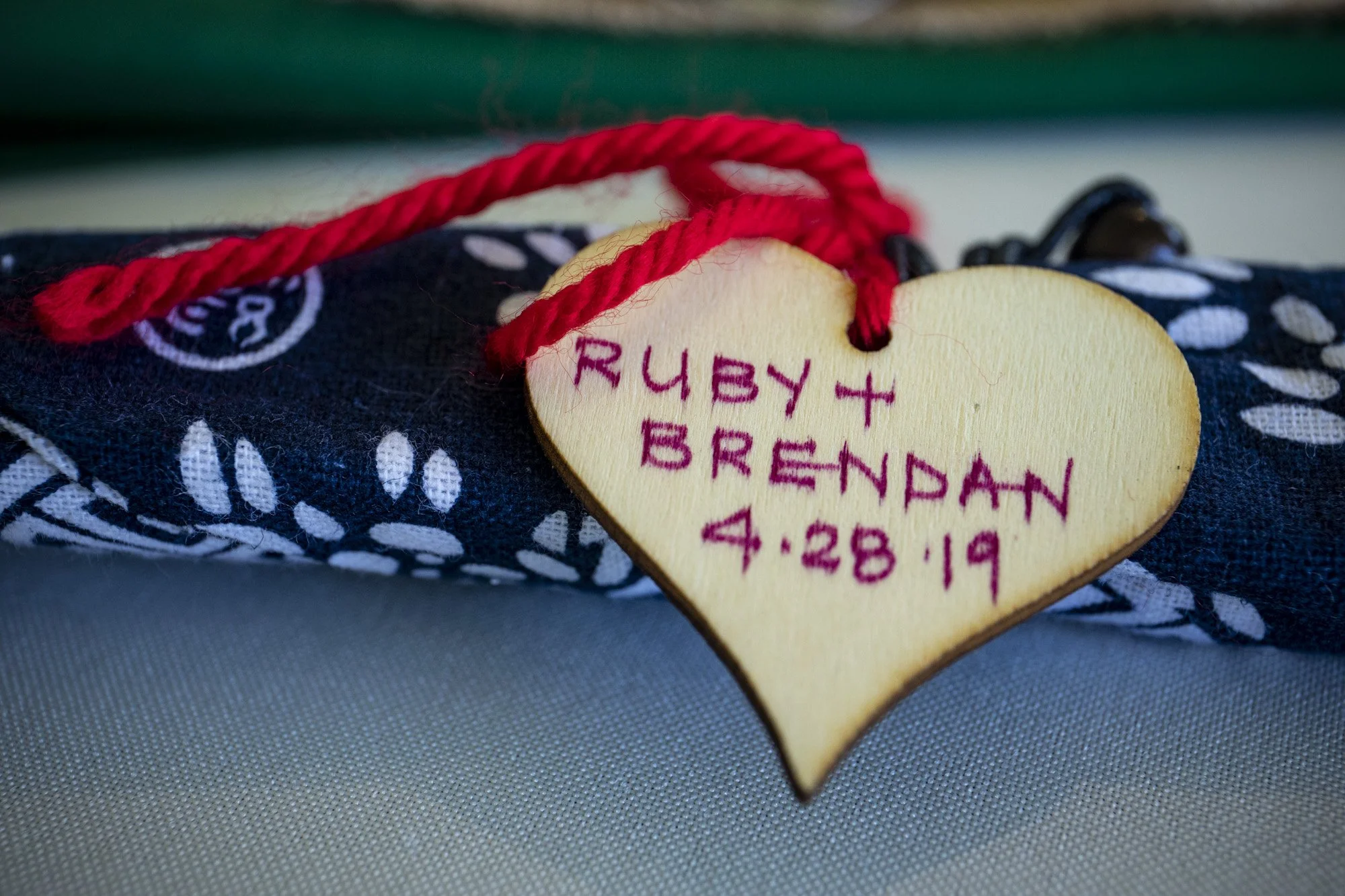 Hand-stitched heart keepsake bearing the couple’s names and wedding date.