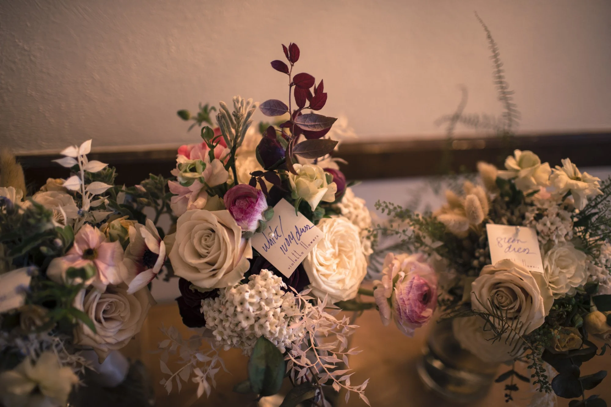 Wedding bouquets arranged beside handwritten place cards.